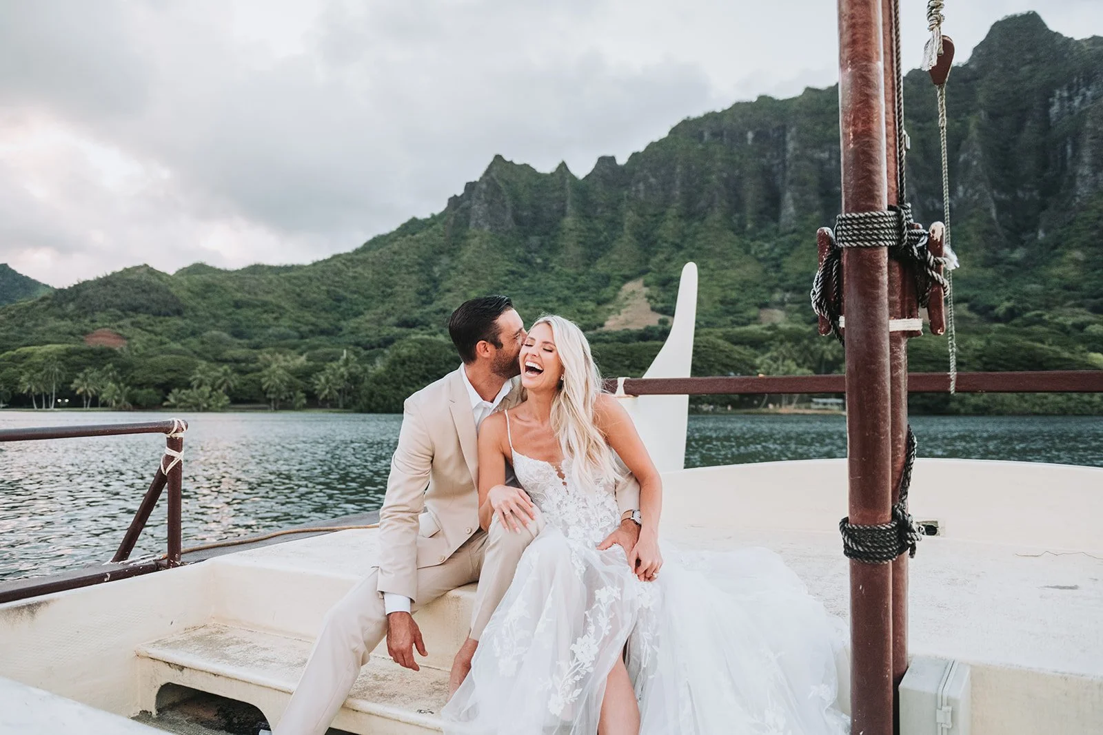 candid-couple-laughing-on-boat-mountain-backdrop.jpg