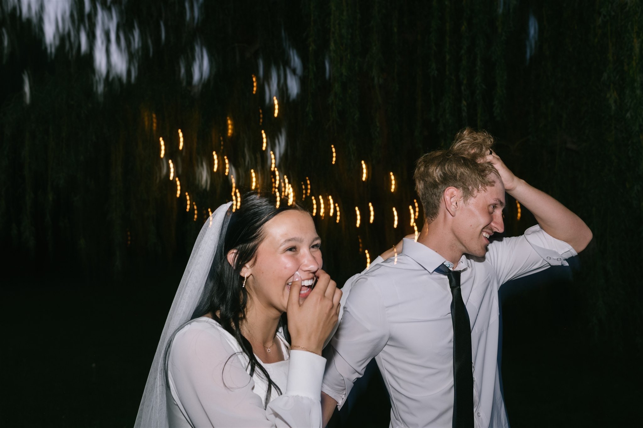 unposed-couple-laughing-at-night.jpg