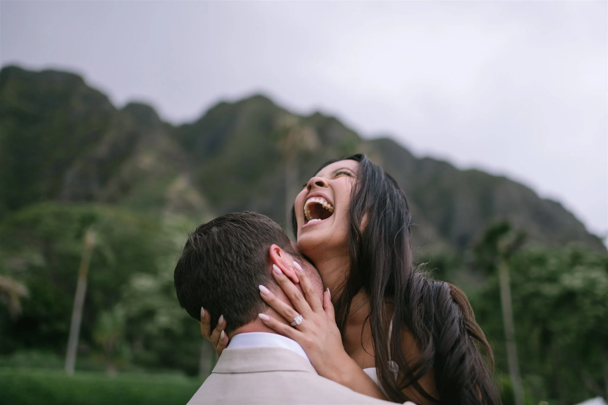 candid-bride-laughing-hugging-groom-mountains.jpg