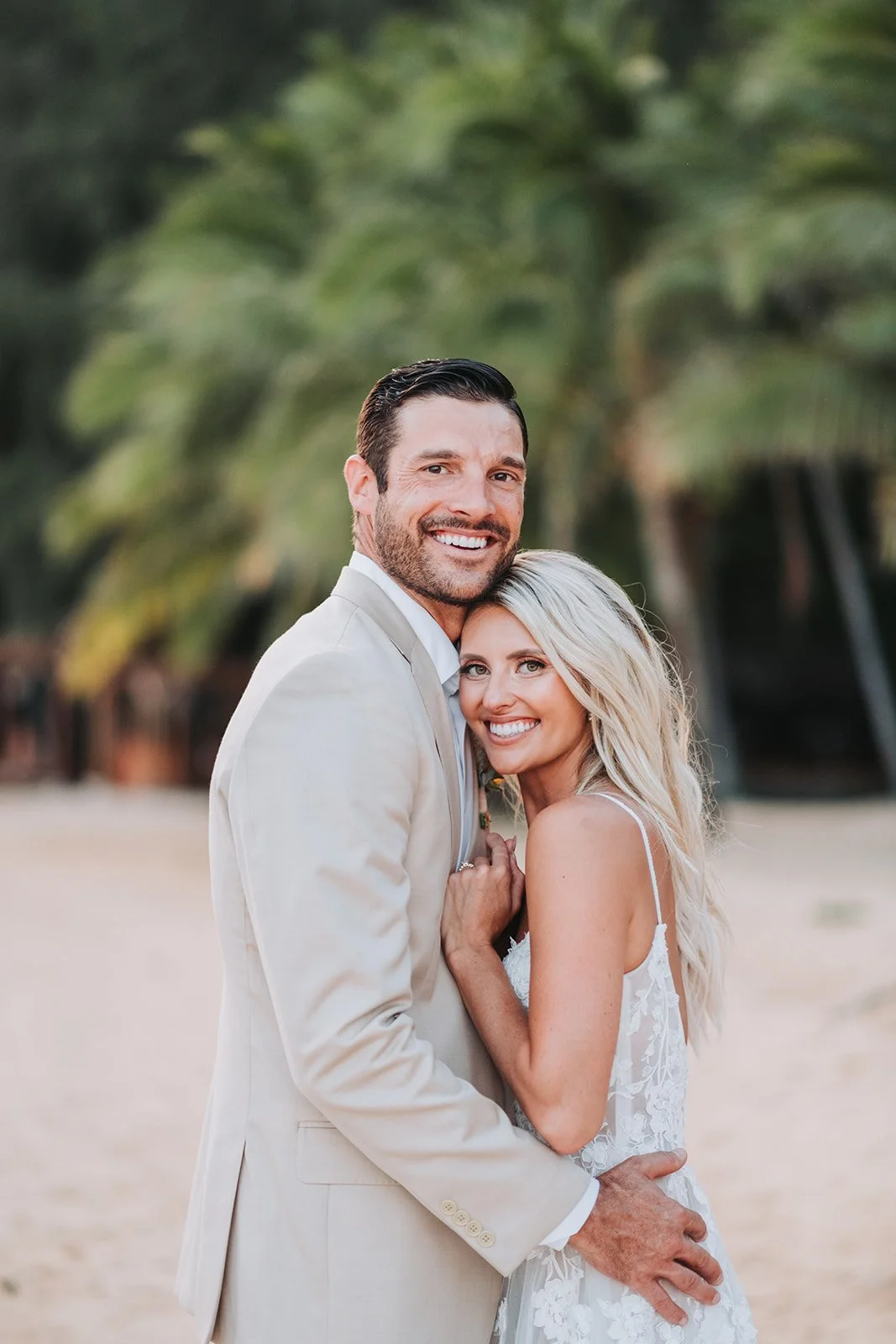 couple-embracing-on-beach-under-palms.jpg