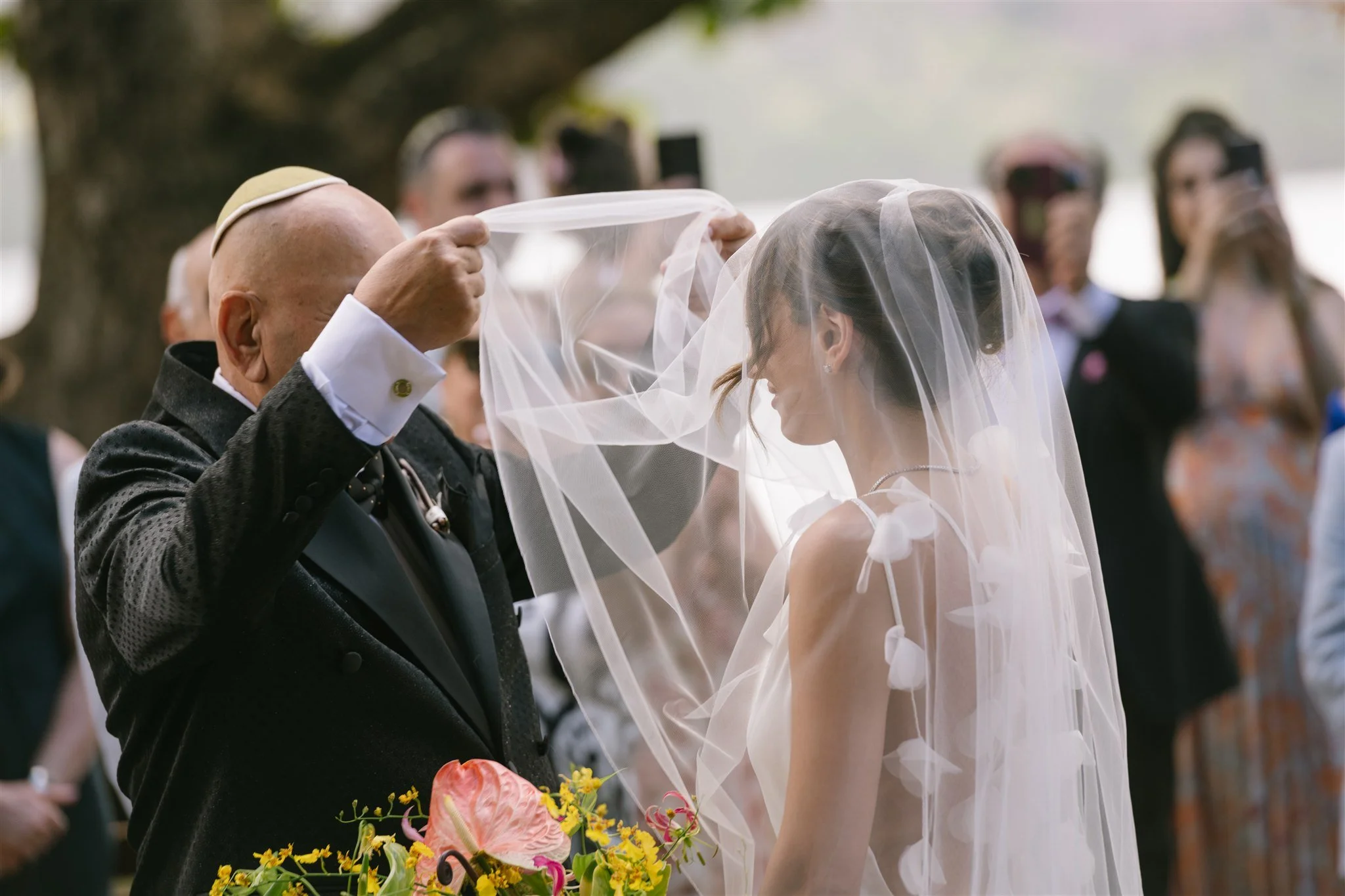 documentary-style-father-blessing-bride-under-veil.jpg