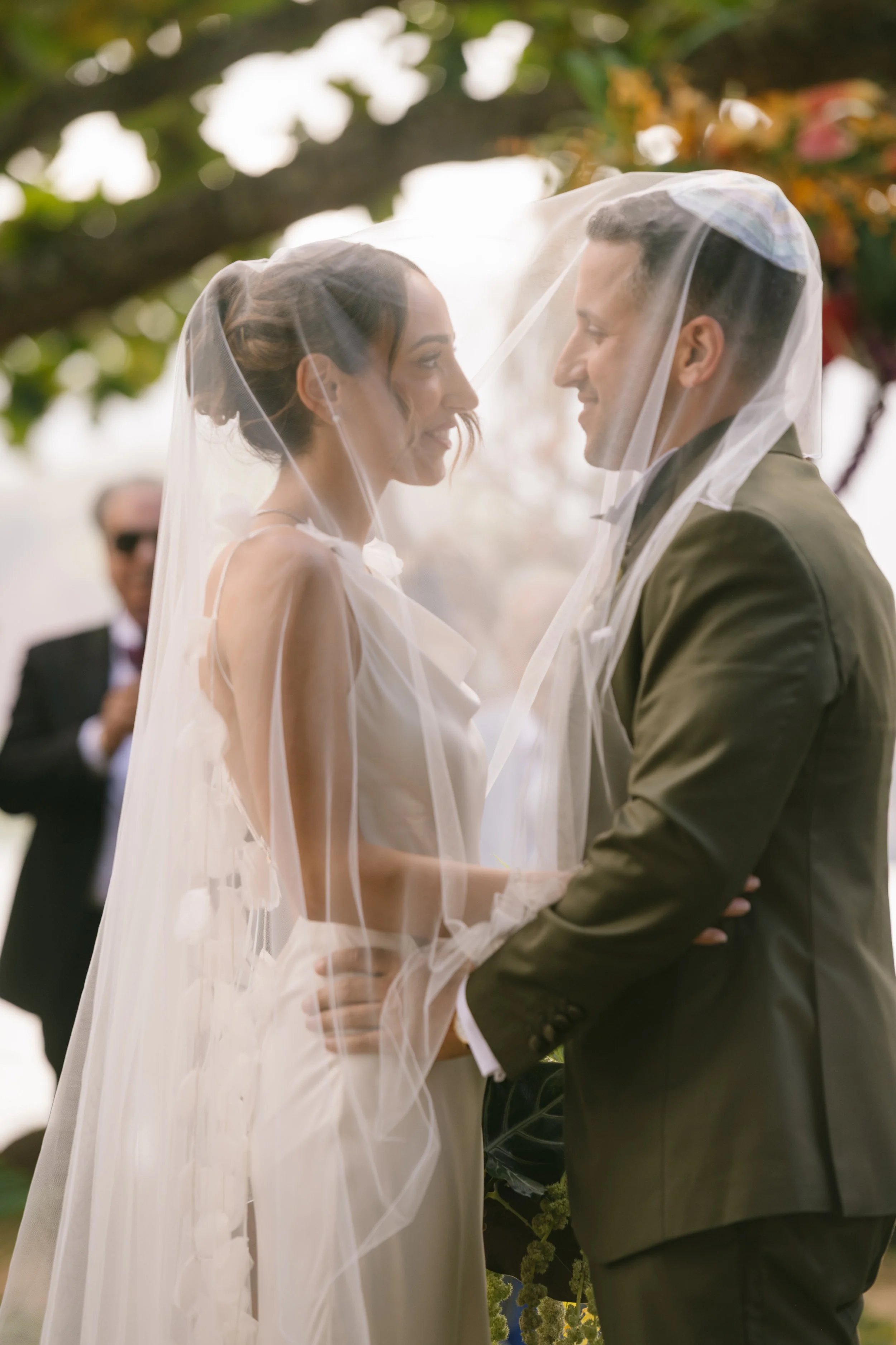documentary-style-couple-under-veil-during-ceremony.jpg