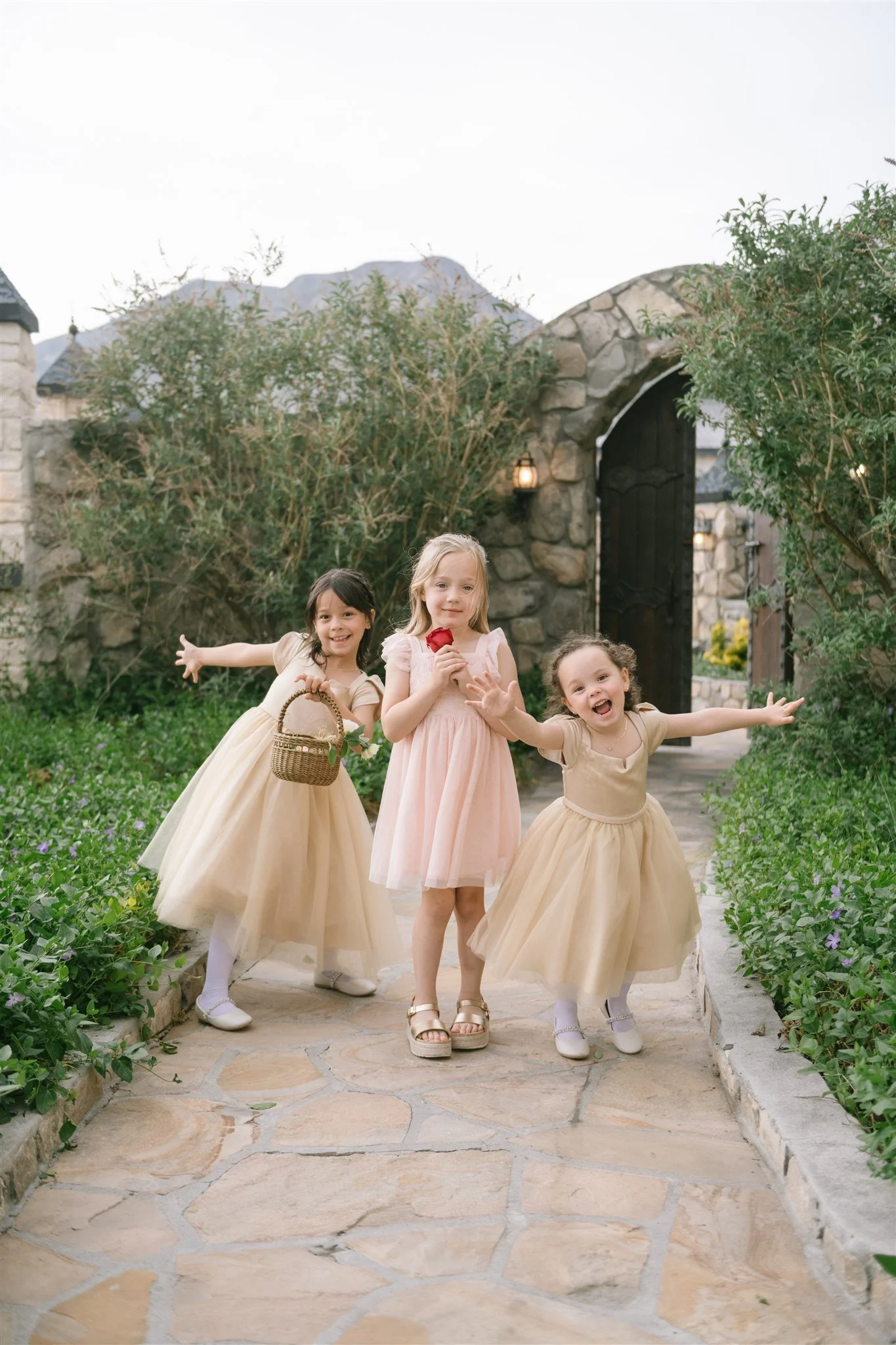candid-flower-girls-playing-on-garden-path.jpg
