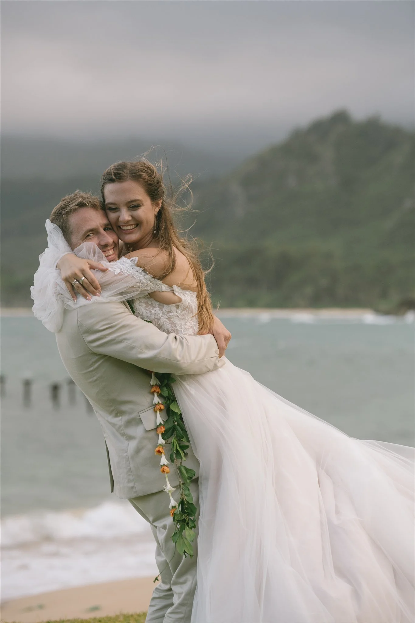 unposed-couple-hugging-on-windy-beach.jpg