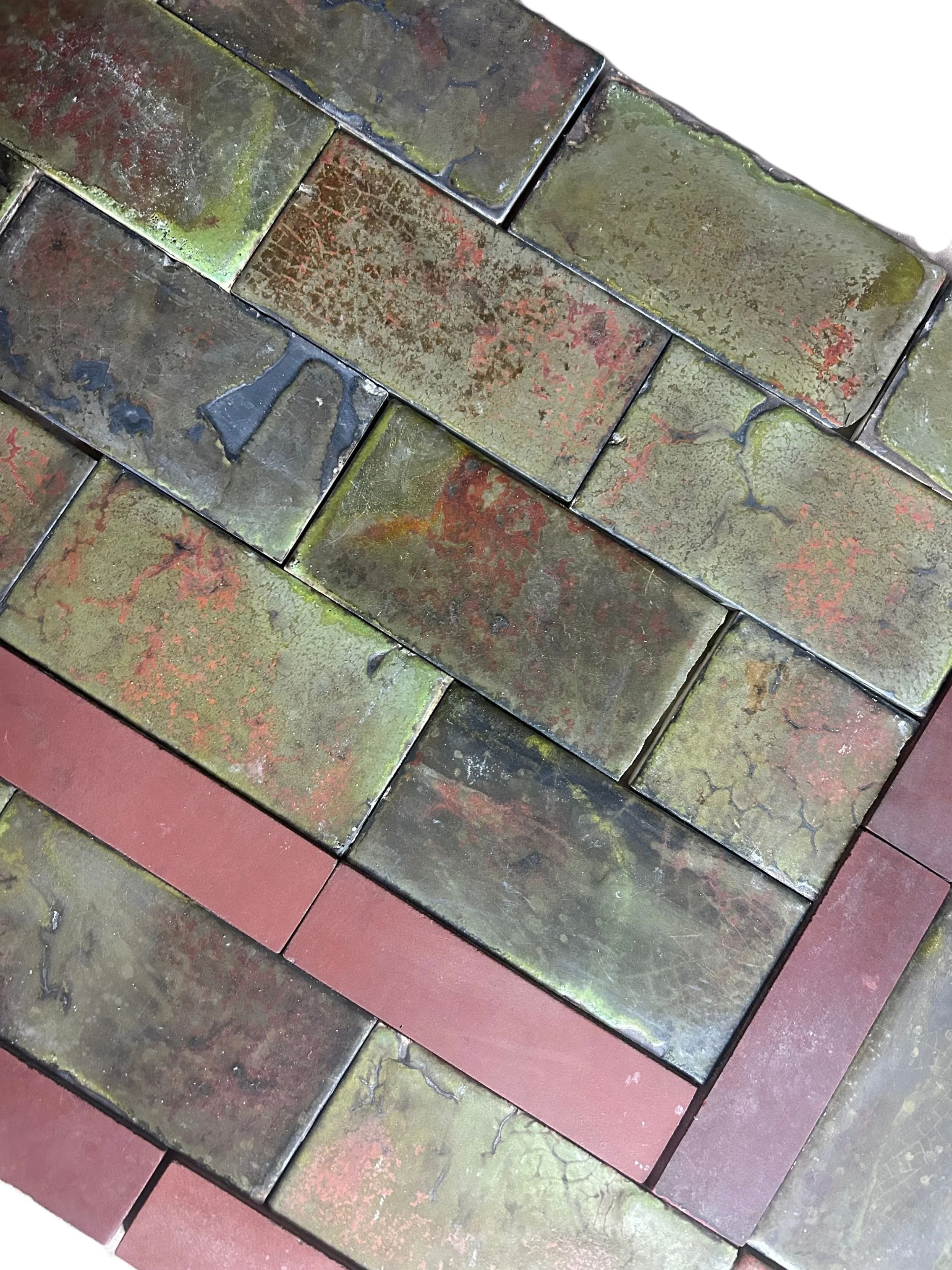 Antique Arts and Crafts Craftsman fireplace surround and hearth featuring mottled olive green, brown, and red tiles with richly varied, earthy glazes.