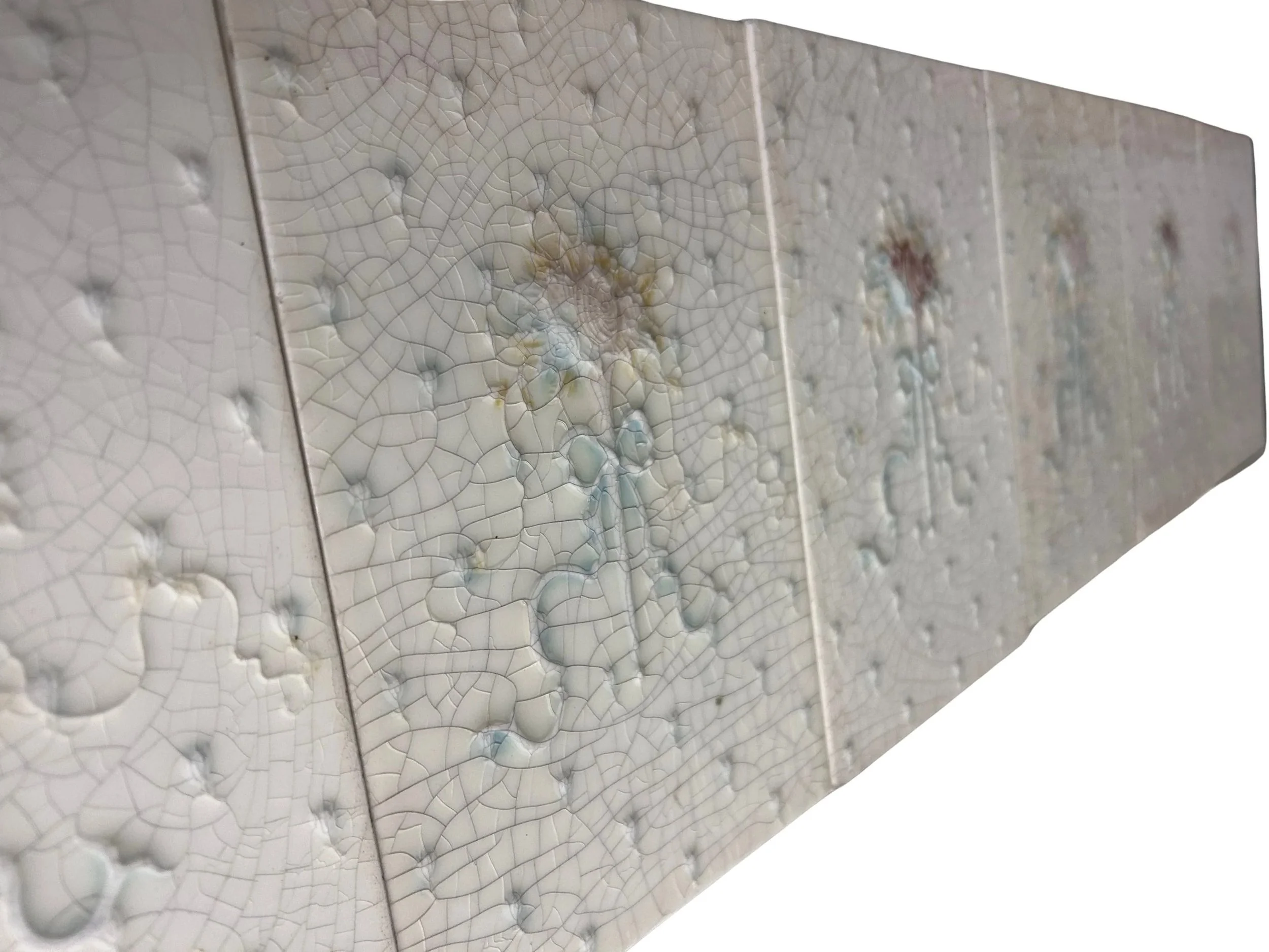 Antique Victorian fireplace surround and hearth featuring delicate floral tiles, pale crackle glazes, and soft blue, pink, yellow, and cream details.