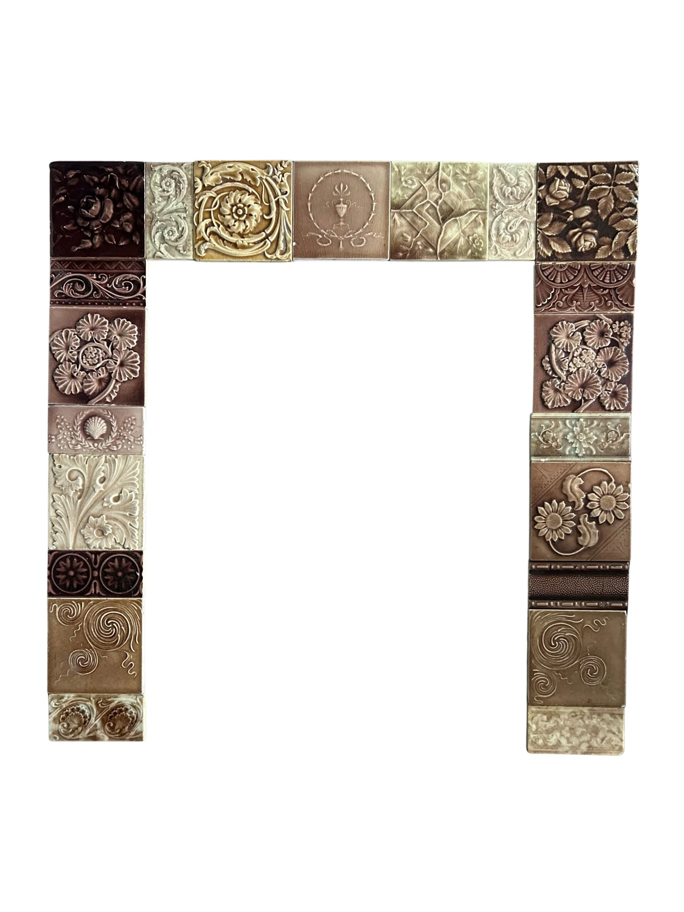 Antique Victorian tile fireplace surround featuring raised floral designs, swirling motifs, and warm brown, olive, and cream glazes.