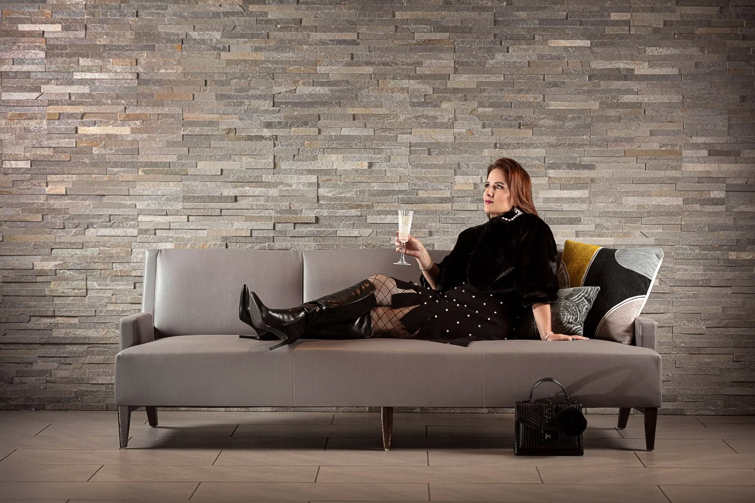 Lifestyle fashion photography Portsmouth NH – Maxxology model with champagne glass in styled commercial shoot.