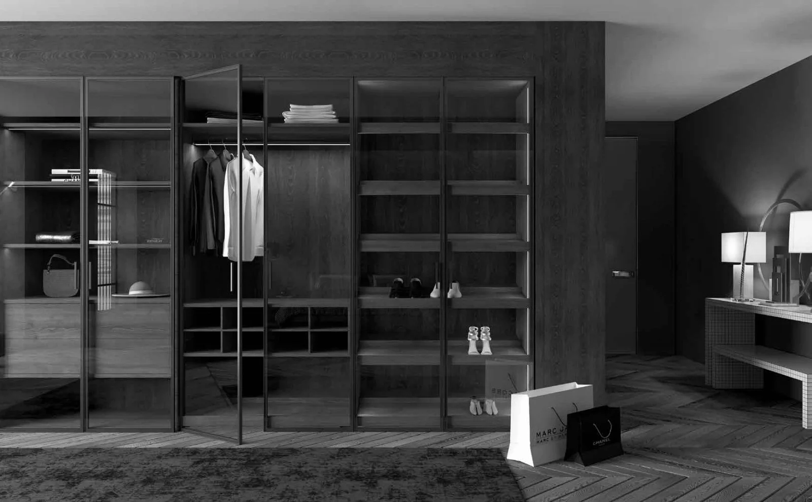 A modern walk-in closet with glass doors, dark wood shelving, and a few hanging clothes. There are shopping bags on the floor, a side table with lamps, and shoes placed on some shelves.