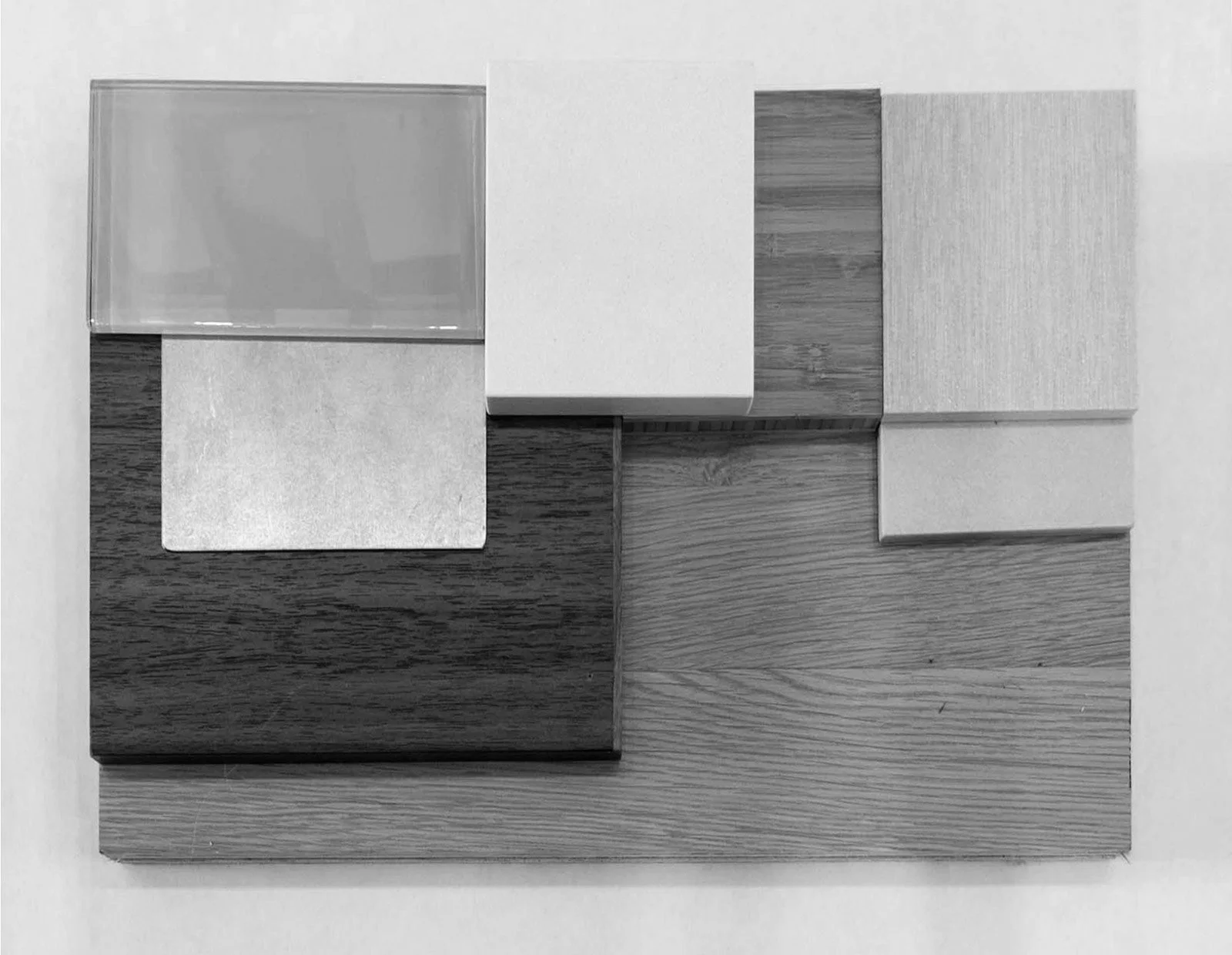 A collection of different textures and shades of wood and material samples arranged on a flat surface.