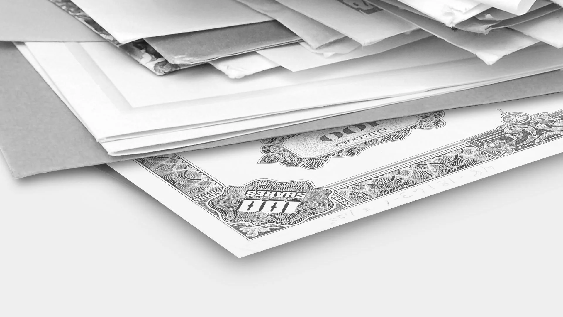 Stack of paper envelopes and newspapers with a dollar bill underneath on a white surface.