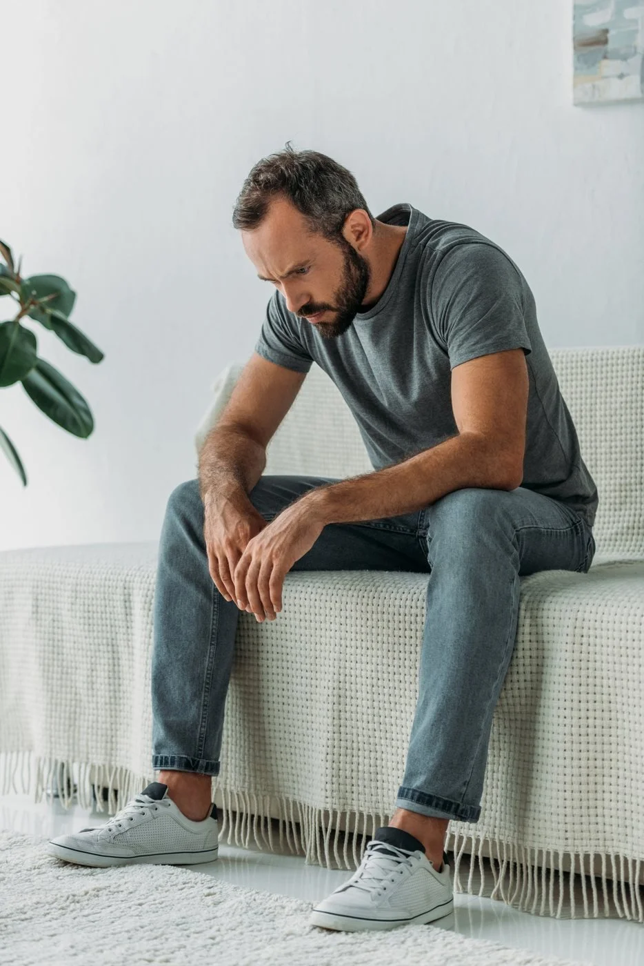 man looking down dealing with anxiety and depression