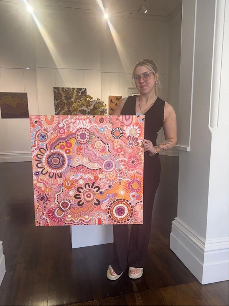 Alisha Fagan holding artwork