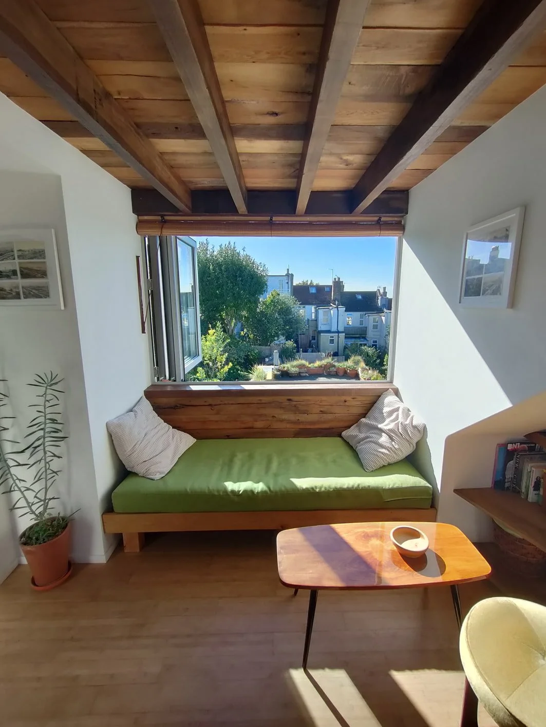 Brighton loft dormer extension showing picture window, seat, and reclaimed timber ceiling - Feron Architects