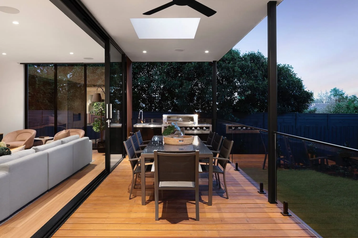 An outdoor dining area with external lighting and appliances, which would be set up by a domestic electrician.