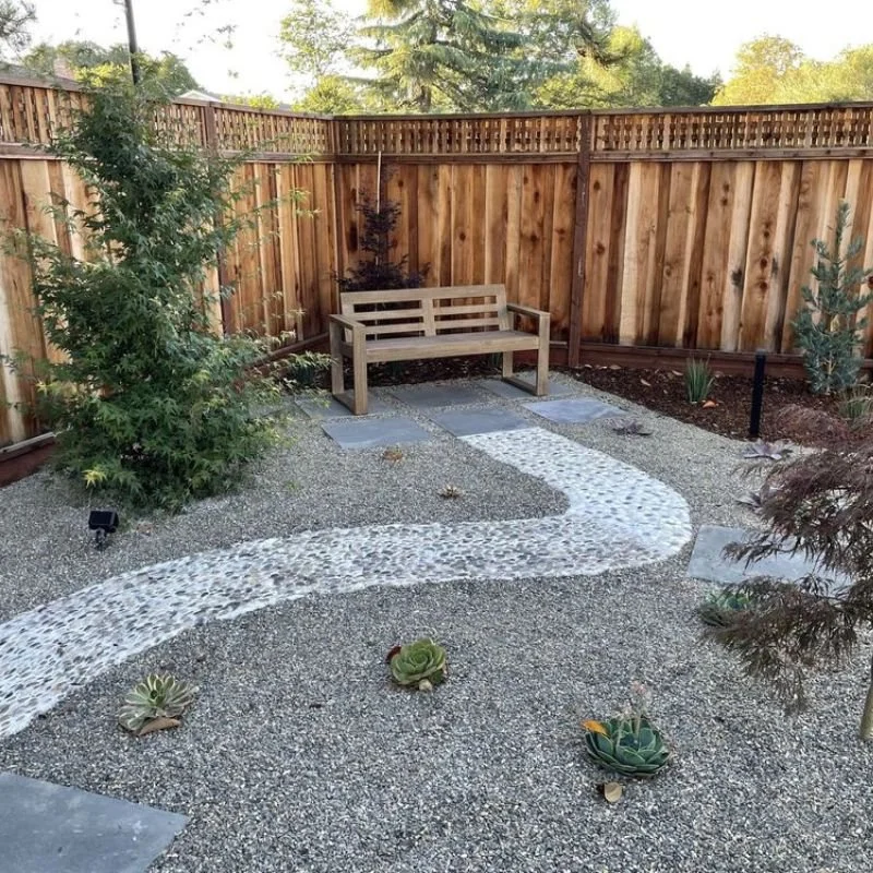 a stone path leading to a bench
