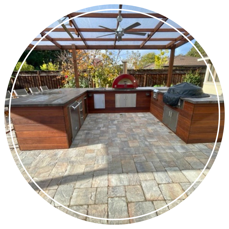 Large residential outdoor kitchen with a pizza oven