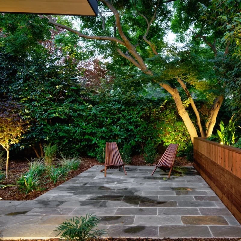 a stone patio with chairs
