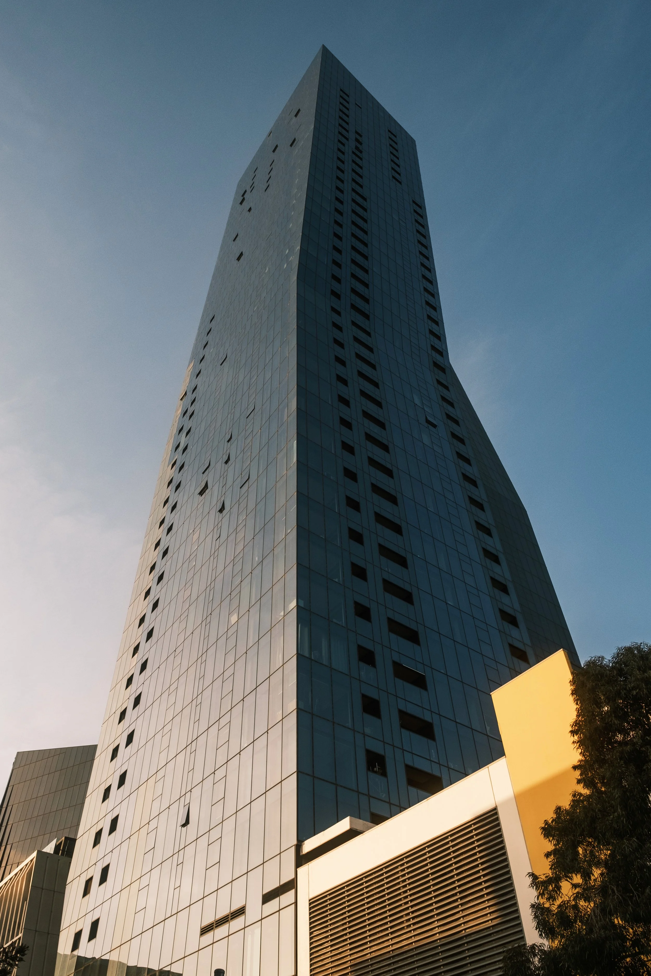 Not a trick photo, the building really is bent in the middle. Docklands, Melbourne, September 2023