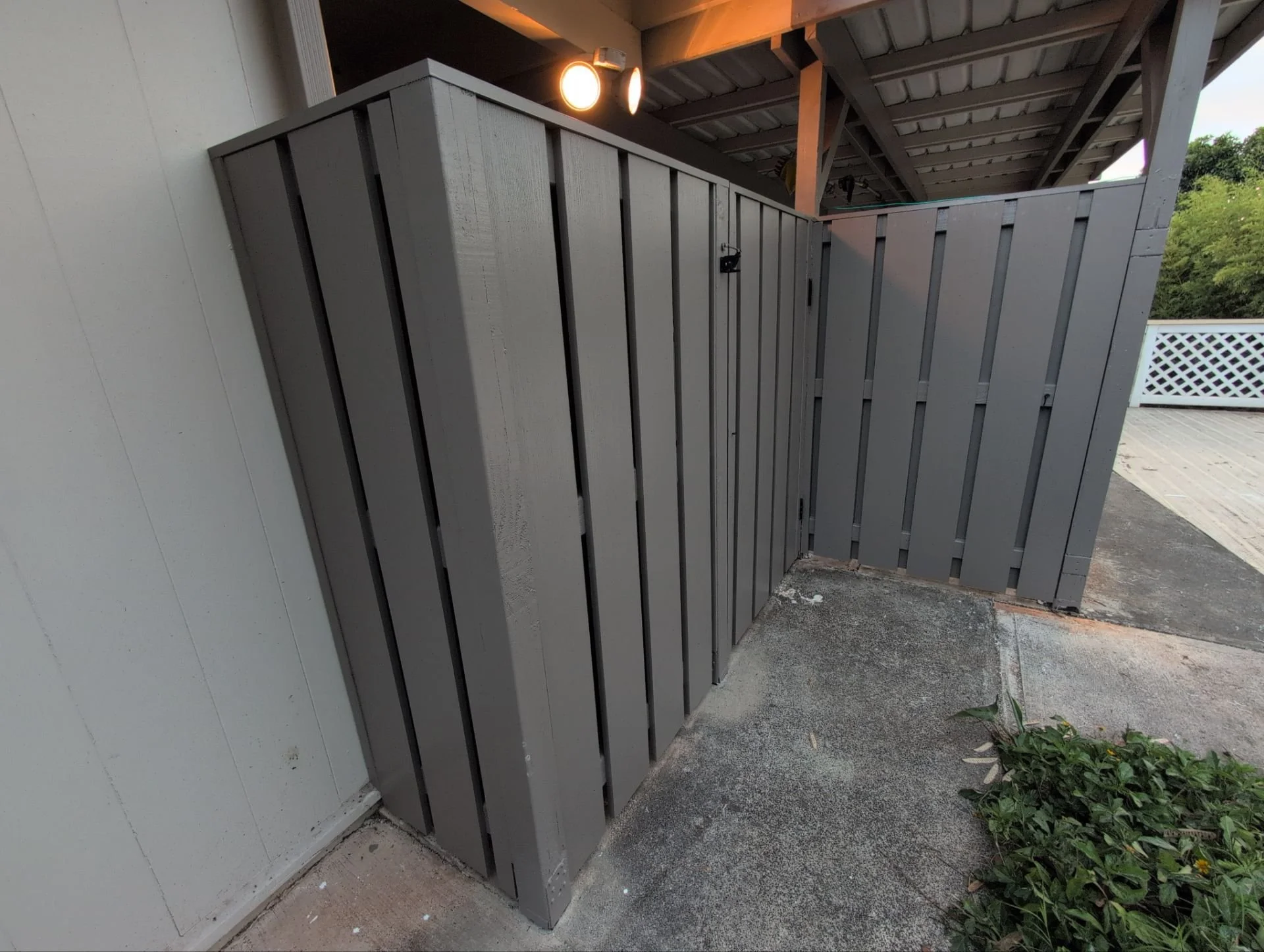 Wooden fence rebuilt using pressure treated lumber, PVC slats / top cap, plus primer & 2 coats of paint