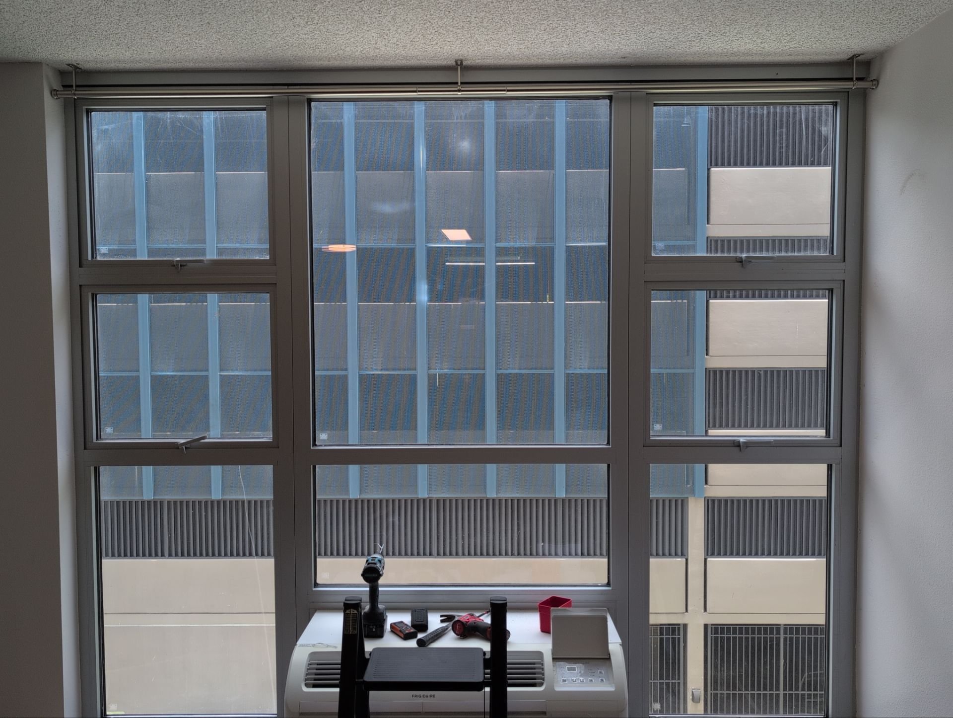 Vertical blinds removed, ceiling-mount curtain rods installed