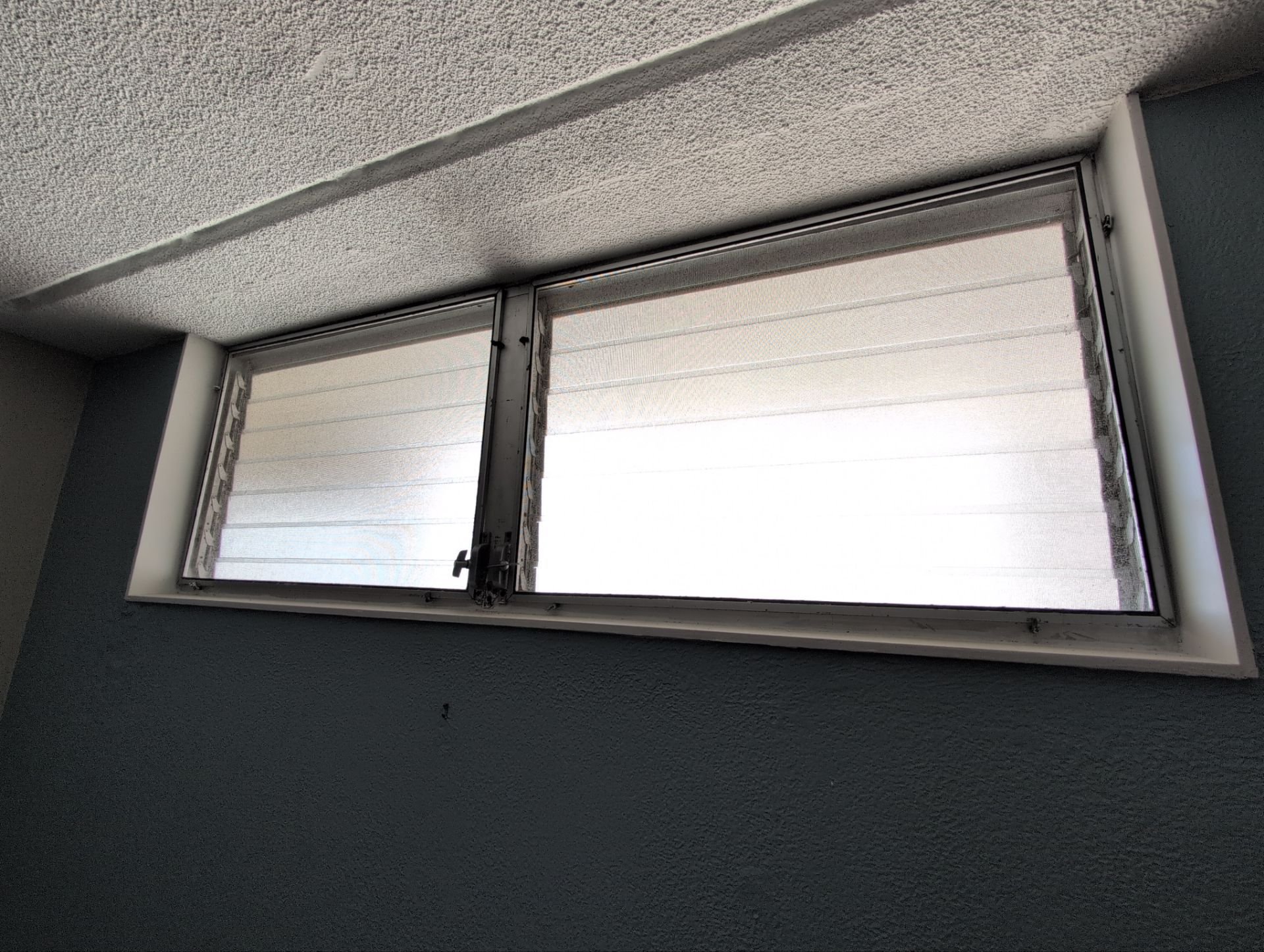 Palmair jalousie window retrofit for this condo in Waikiki