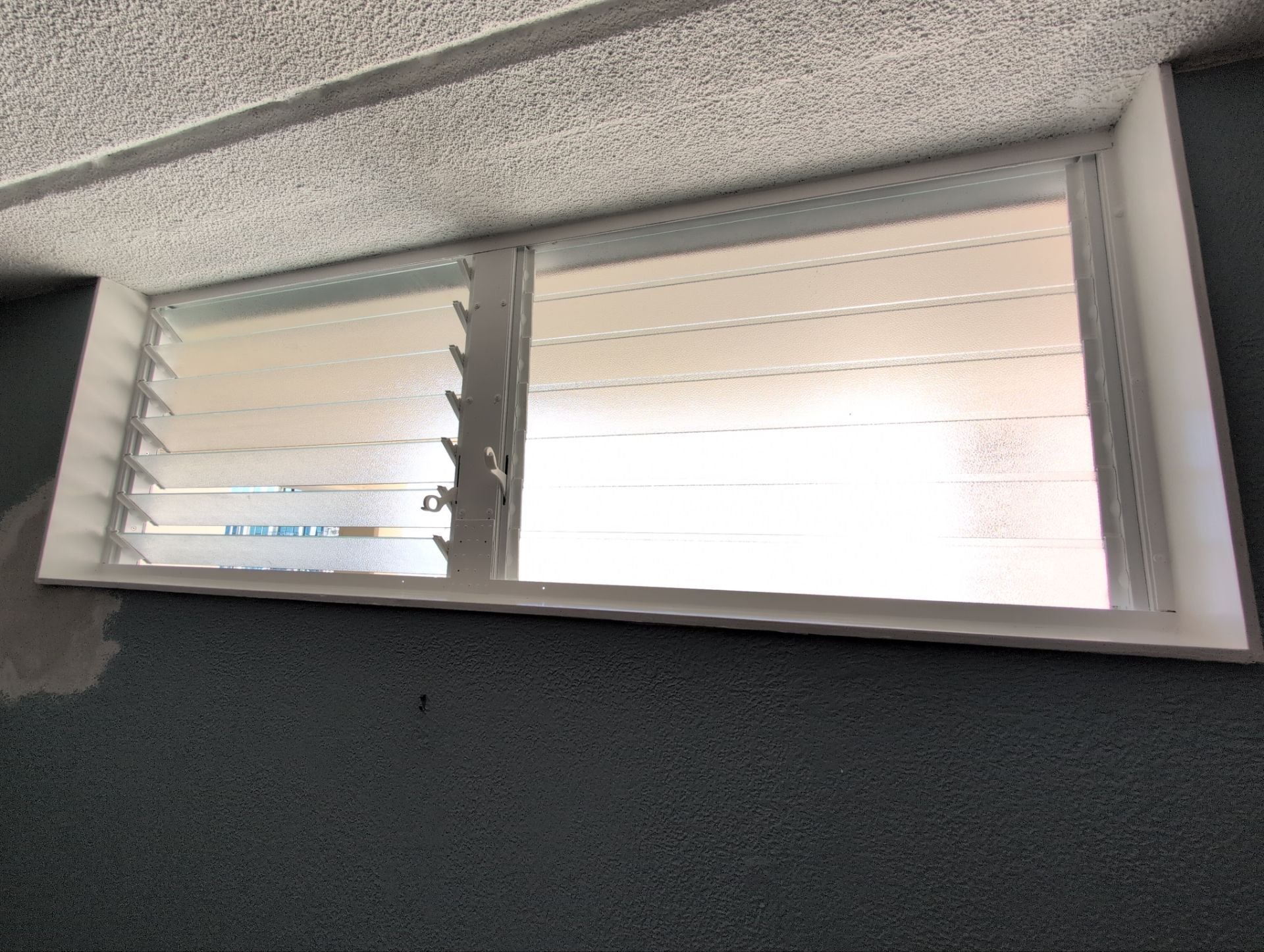 Palmair jalousie window retrofit for this condo in Waikiki