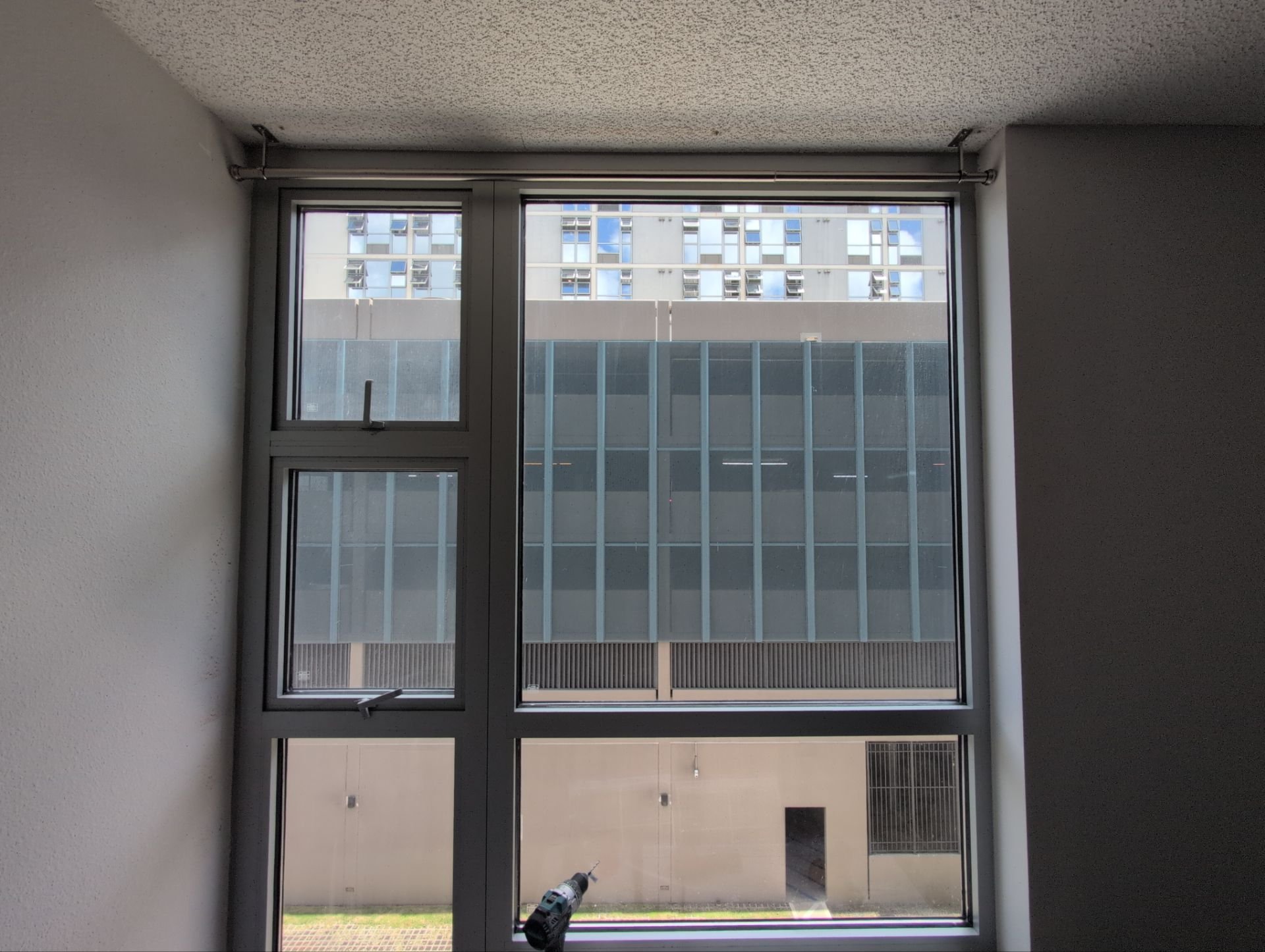 Vertical blinds removed, ceiling-mount curtain rods installed