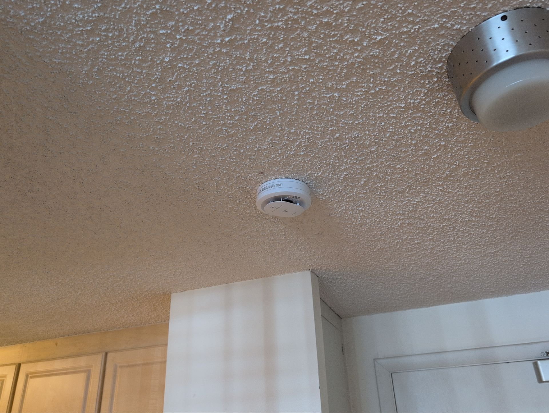 Work at this unit included replacing smoke detectors, repairing a sliding door latch, and a bathtub/shower re-caulk