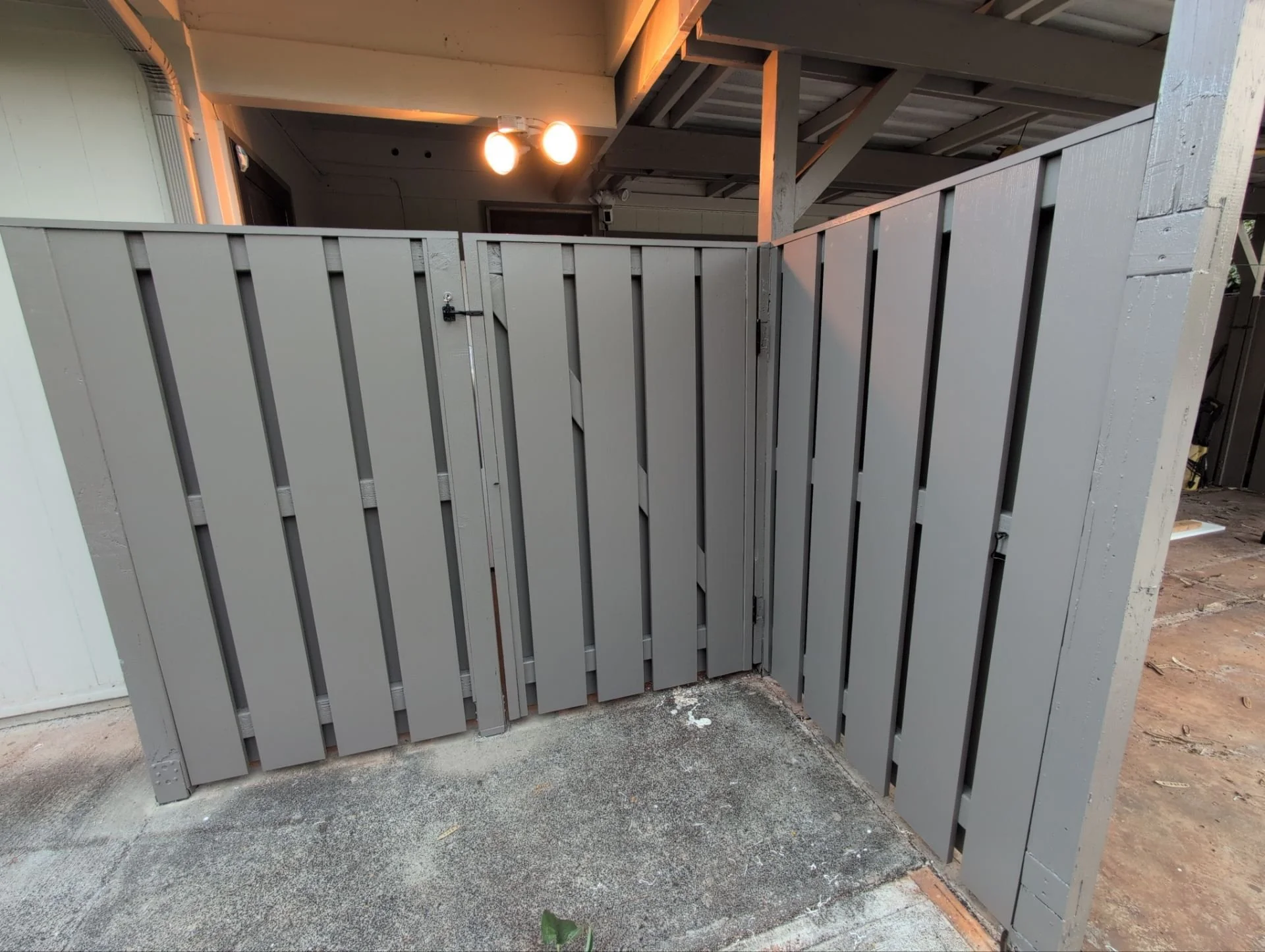 Wooden fence rebuilt using pressure treated lumber, PVC slats / top cap, plus primer & 2 coats of paint