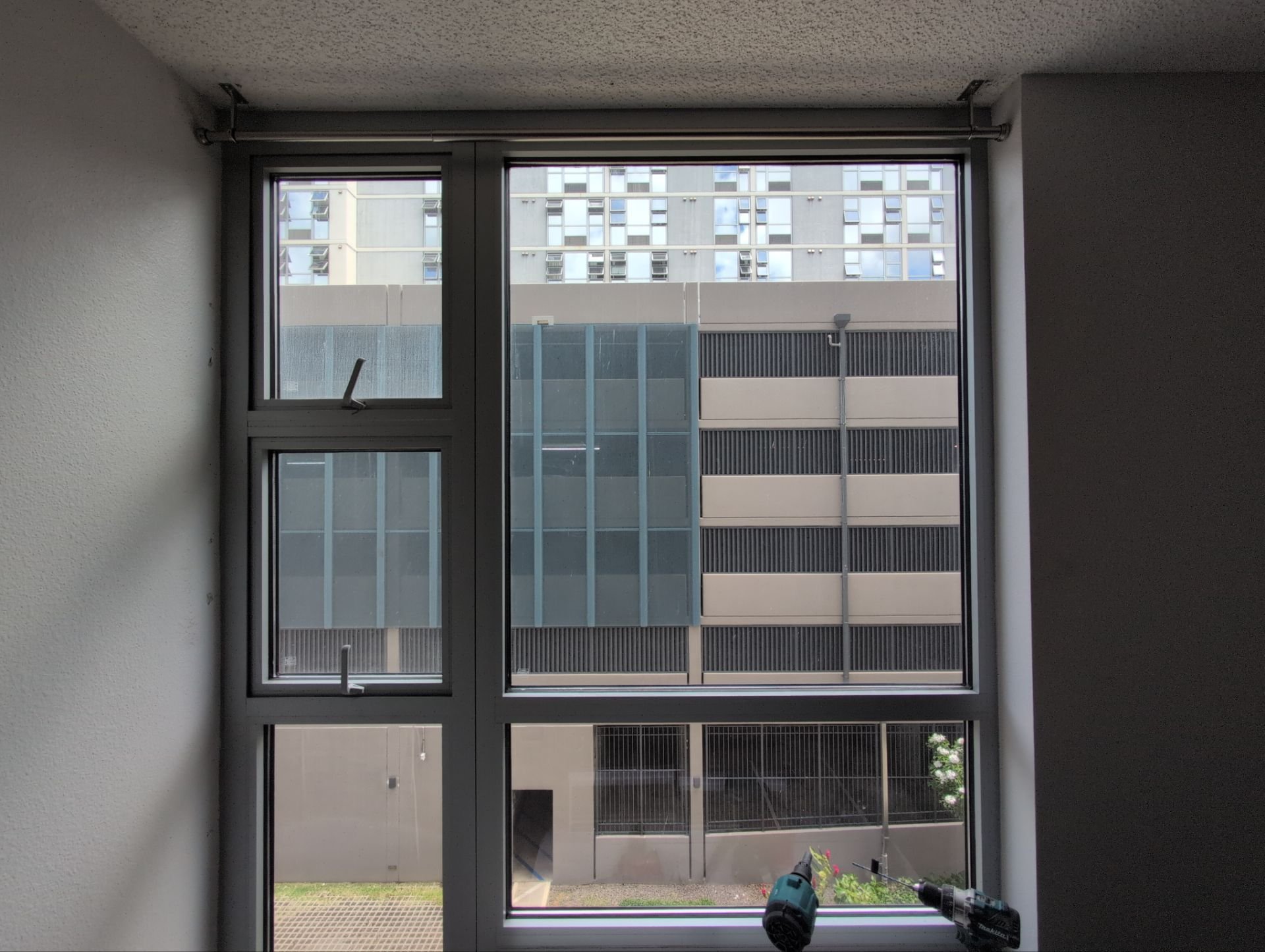 Vertical blinds removed, ceiling-mount curtain rods installed
