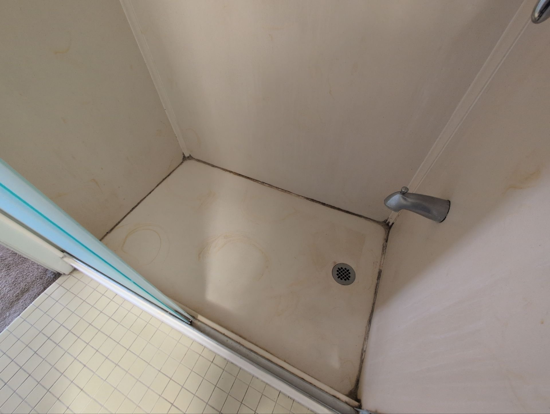 Work at this unit included replacing smoke detectors, repairing a sliding door latch, and a bathtub/shower re-caulk