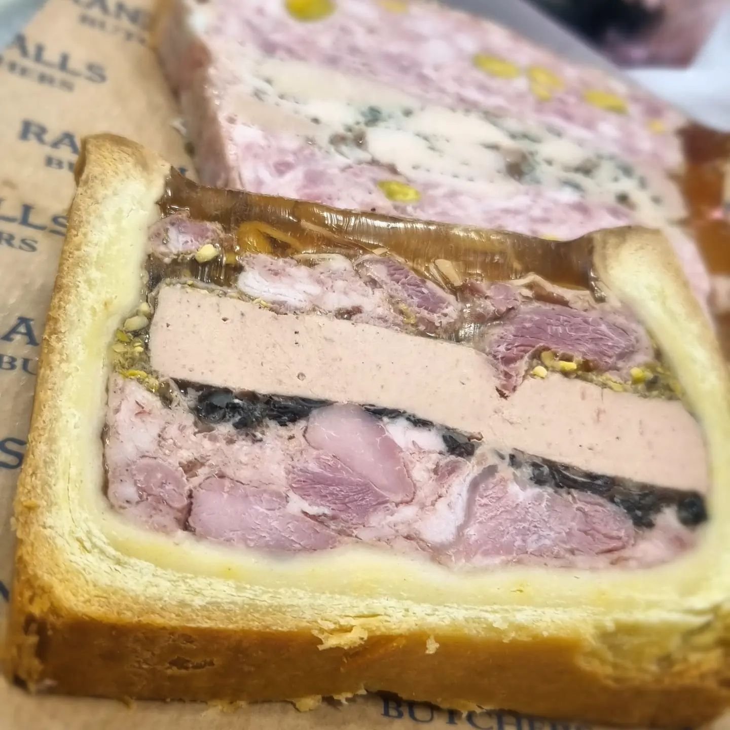 We have some new P&acirc;t&eacute;s in... The en croute has fois gras, pork cheek, duck breast with pistachio and forest mushroom. The other one here has pork, chicken, tarragon and pistachio. They are SO good. #randallsbutchers #wandsworthbridgeroad