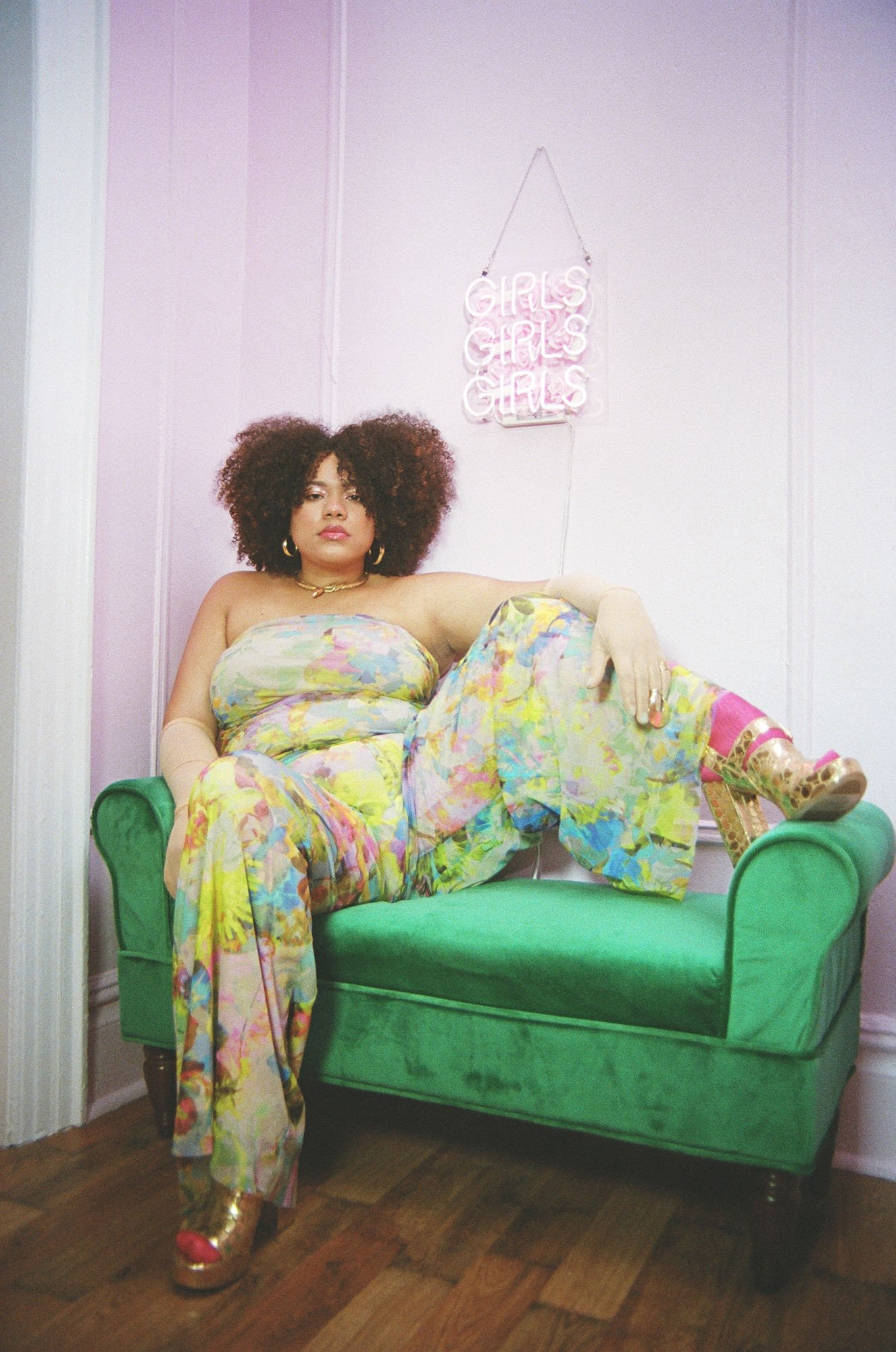  Editorial Photoshoot Styled by Charlotte Sims —&nbsp;A woman sitting on a couch posing wearing fashionable clothes. 