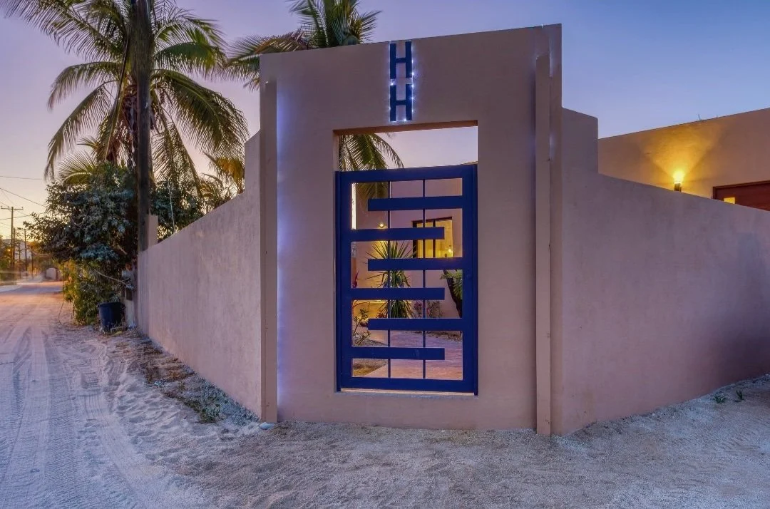 Exterior front gate leading into the entrance of a boutique hotel in Los Barriles.