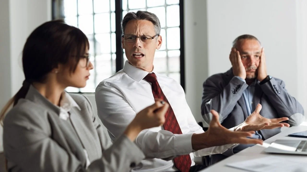 Man in a meeting communicating his anger