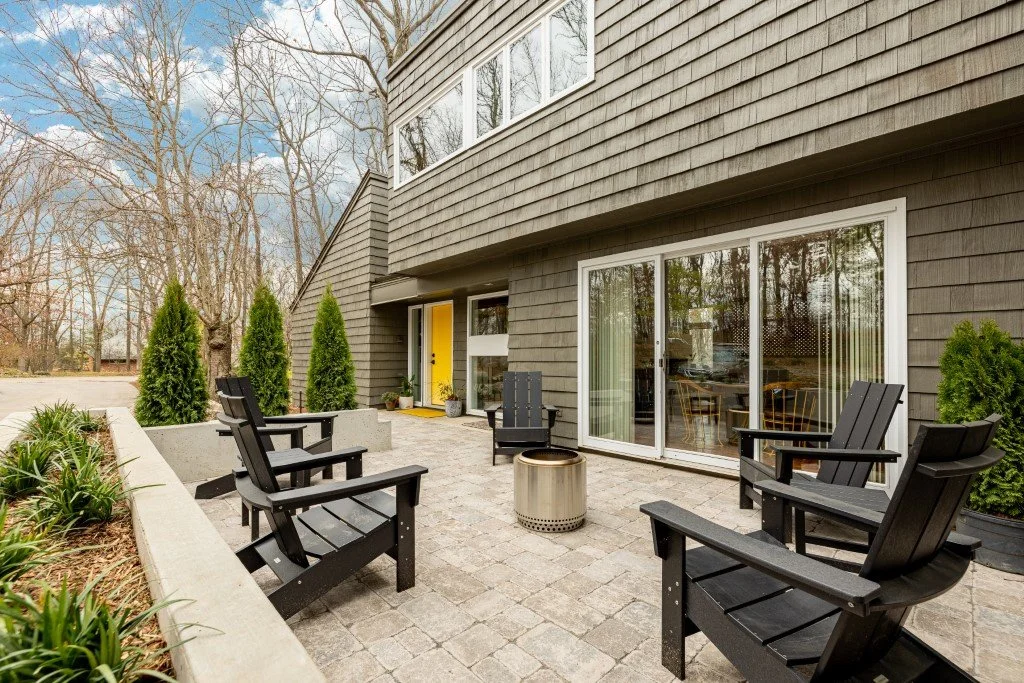 Custom patio with outdoor furniture and various shrubs