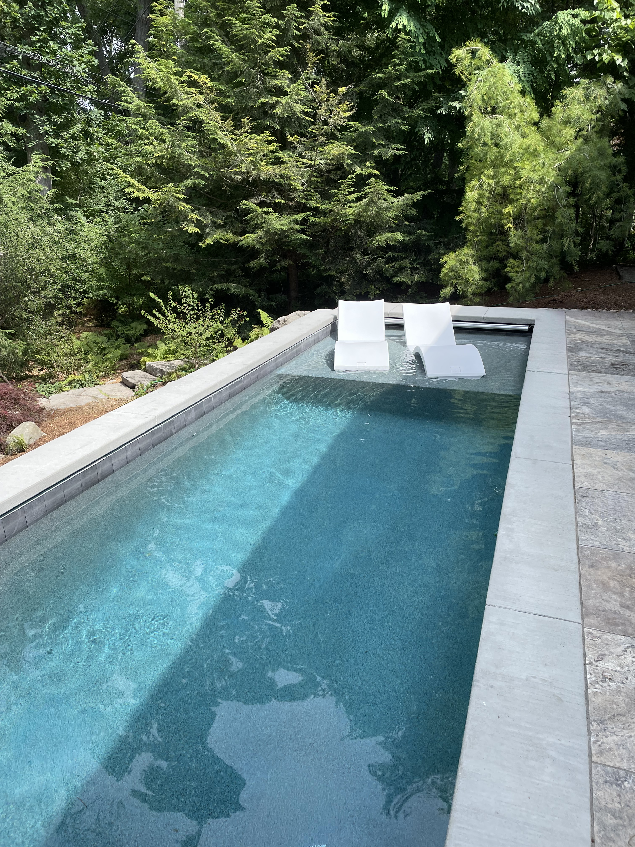 Custom pool with floating chairs