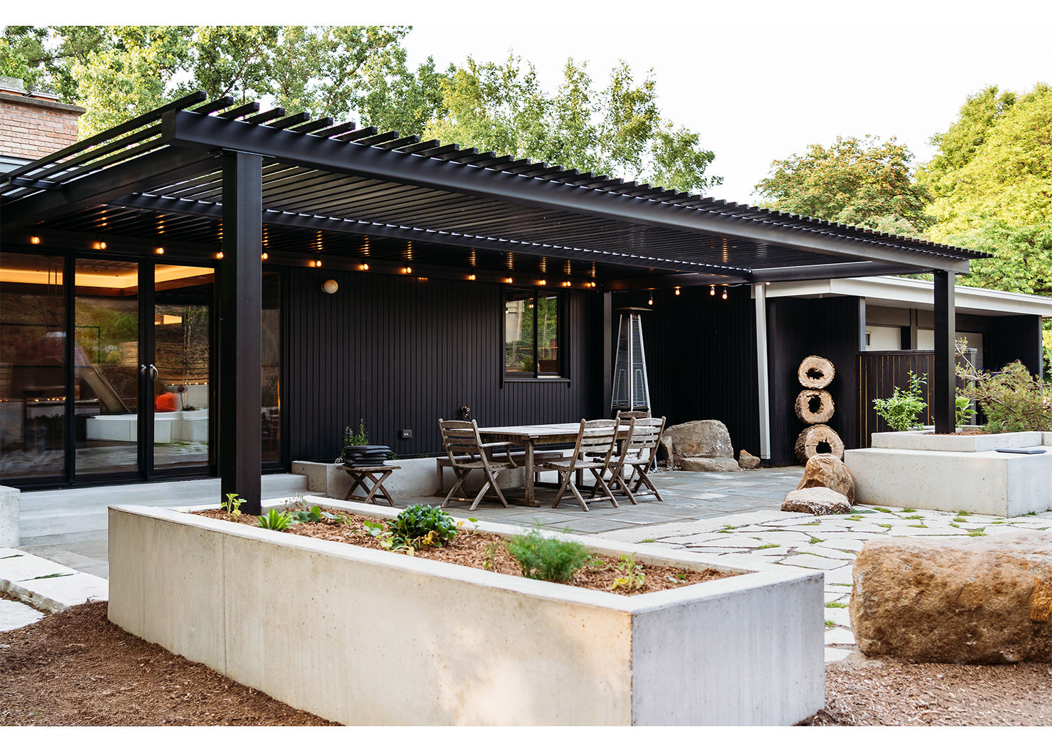 Pergola over custom patio with lighting and planters
