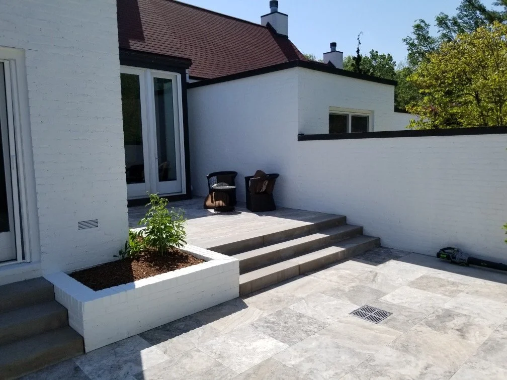 Stone entryway with small steps and built in planters