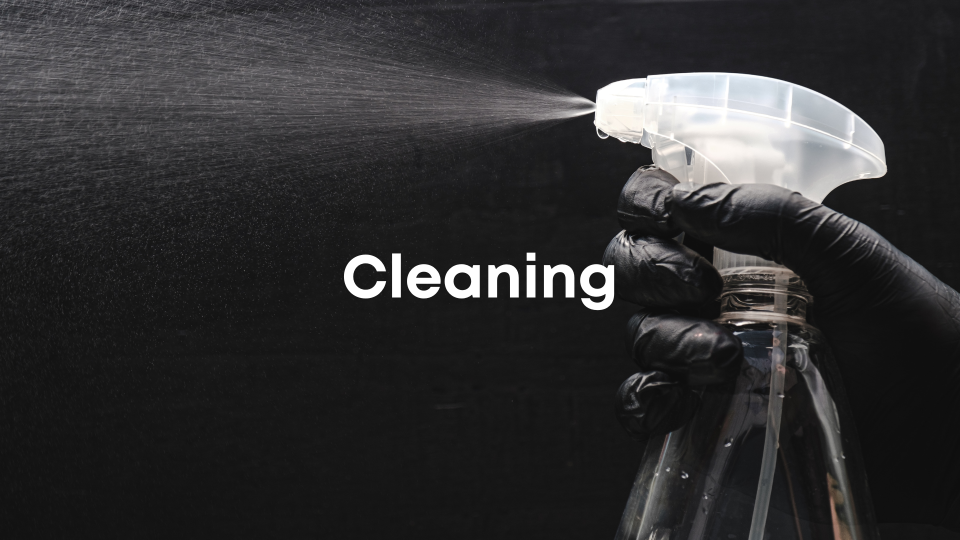 A hand wearing a black glove holding a spray bottle, spraying cleaning solution onto a dark surface, with the word 'Cleaning' overlaid.