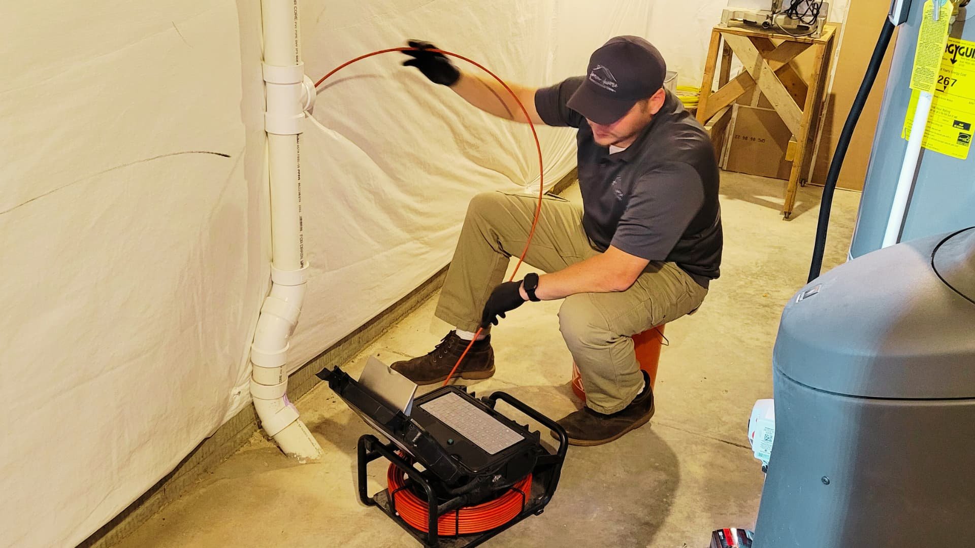 home inspector conducting sewer line inspection with home inspection