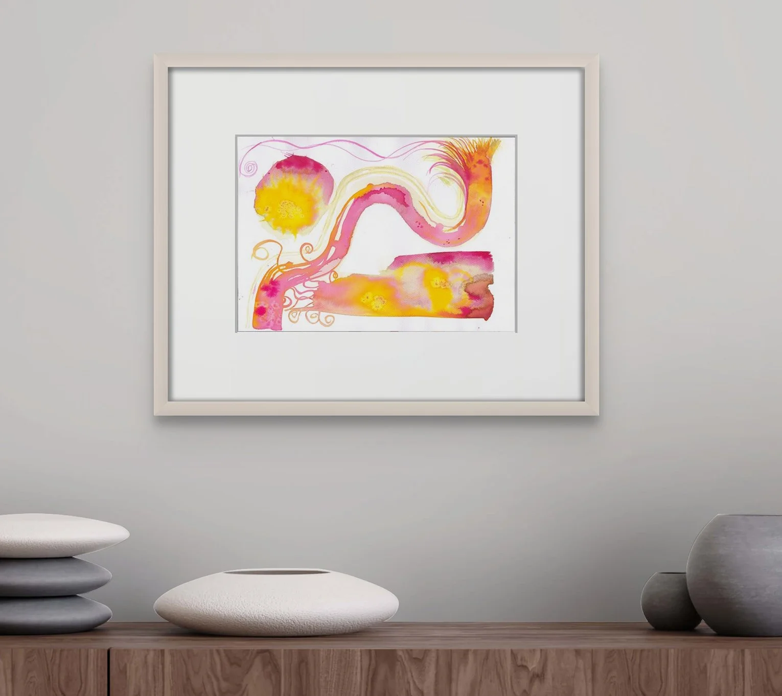 Framed with light wood underglass with mount on grey wall above wooden buffet with white vases on it