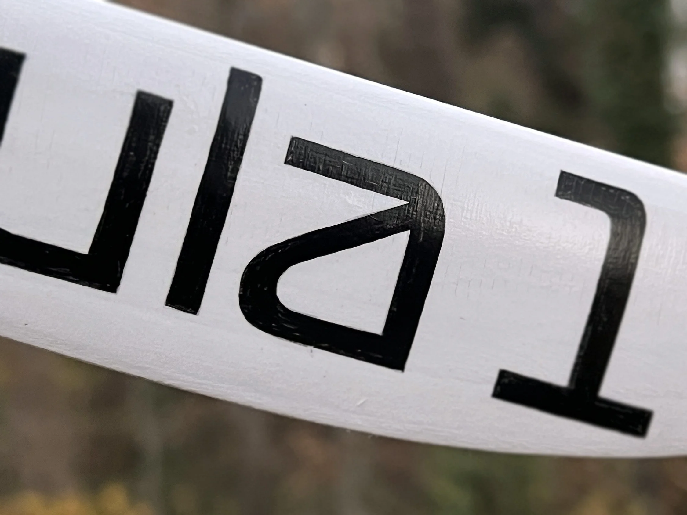 Close-up of hand-painted Formula 1 commissioned boomerang.