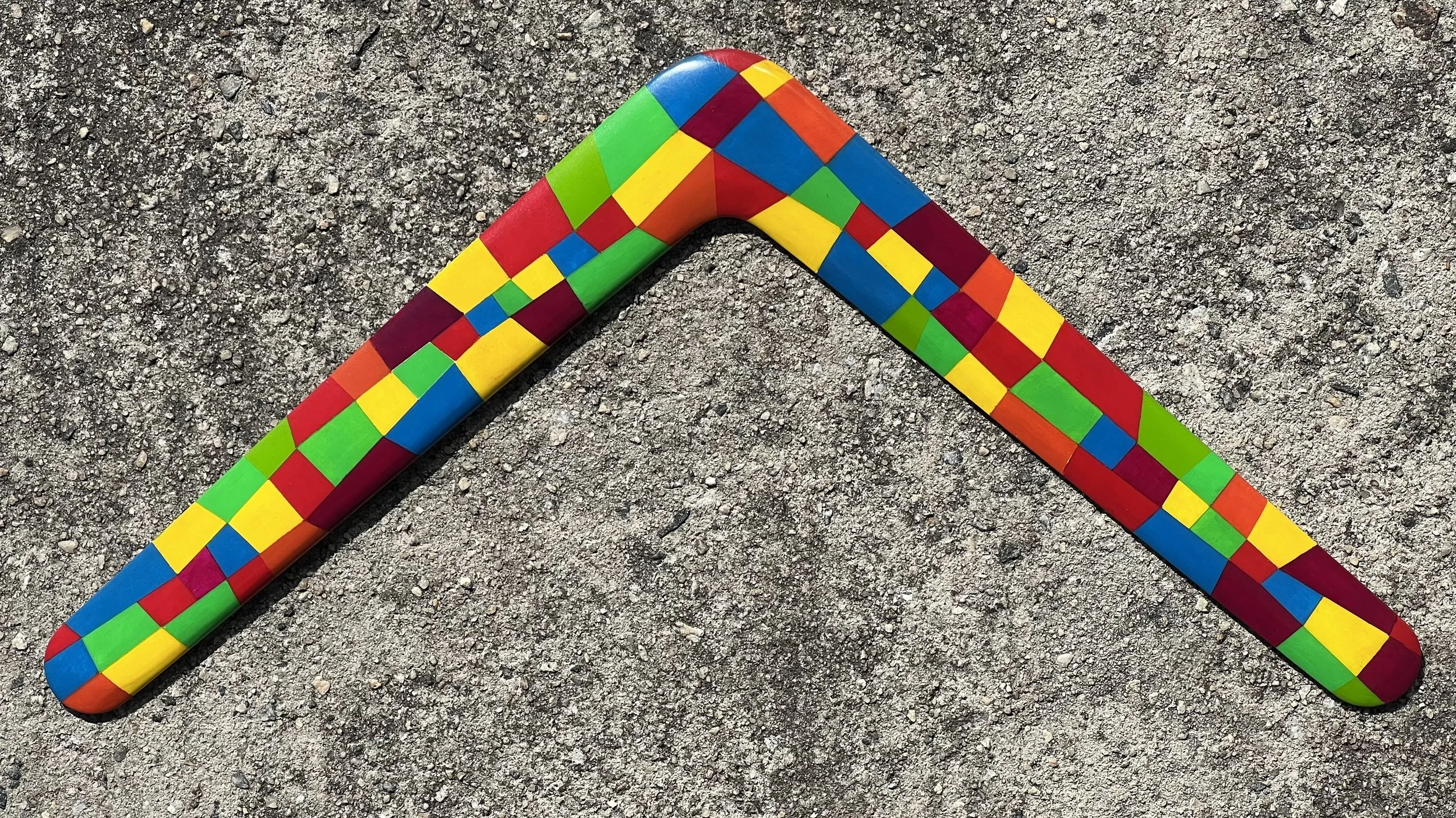 Colorful hand-painted, wood boomerang.