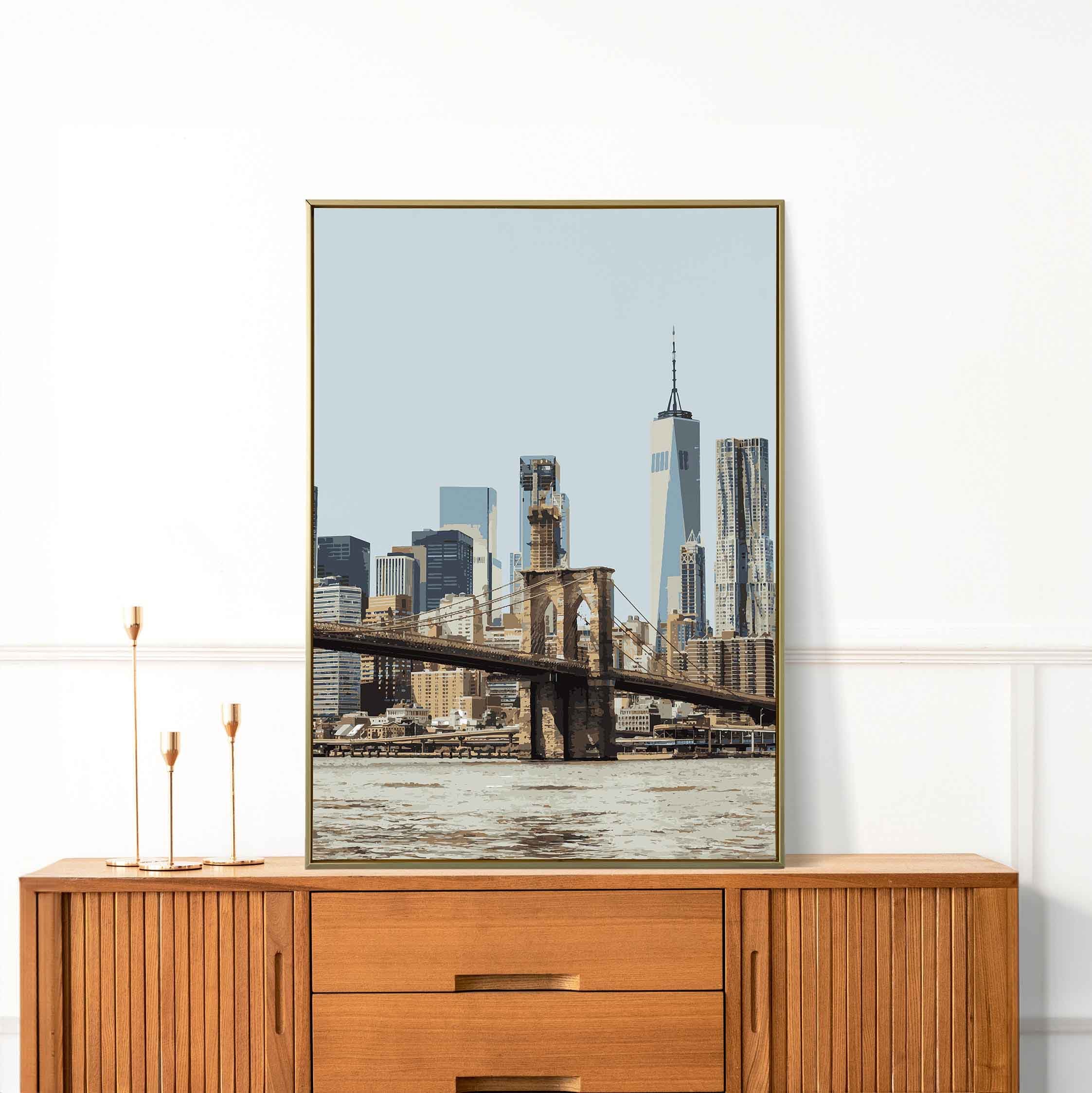 A poster featuring the Brooklyn Bridge on a dresser.