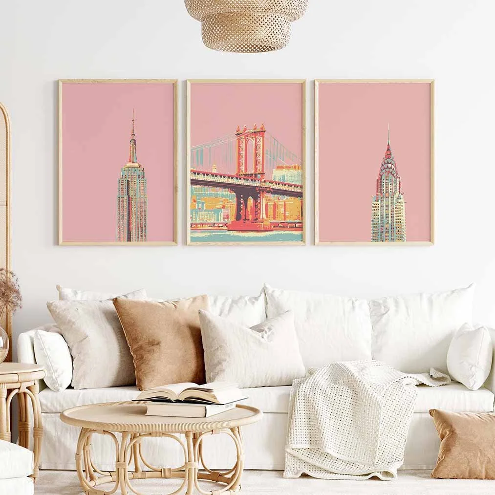 Frontal view of a boho living-room featuring a set of 3 New York prints in pink on the wall.
