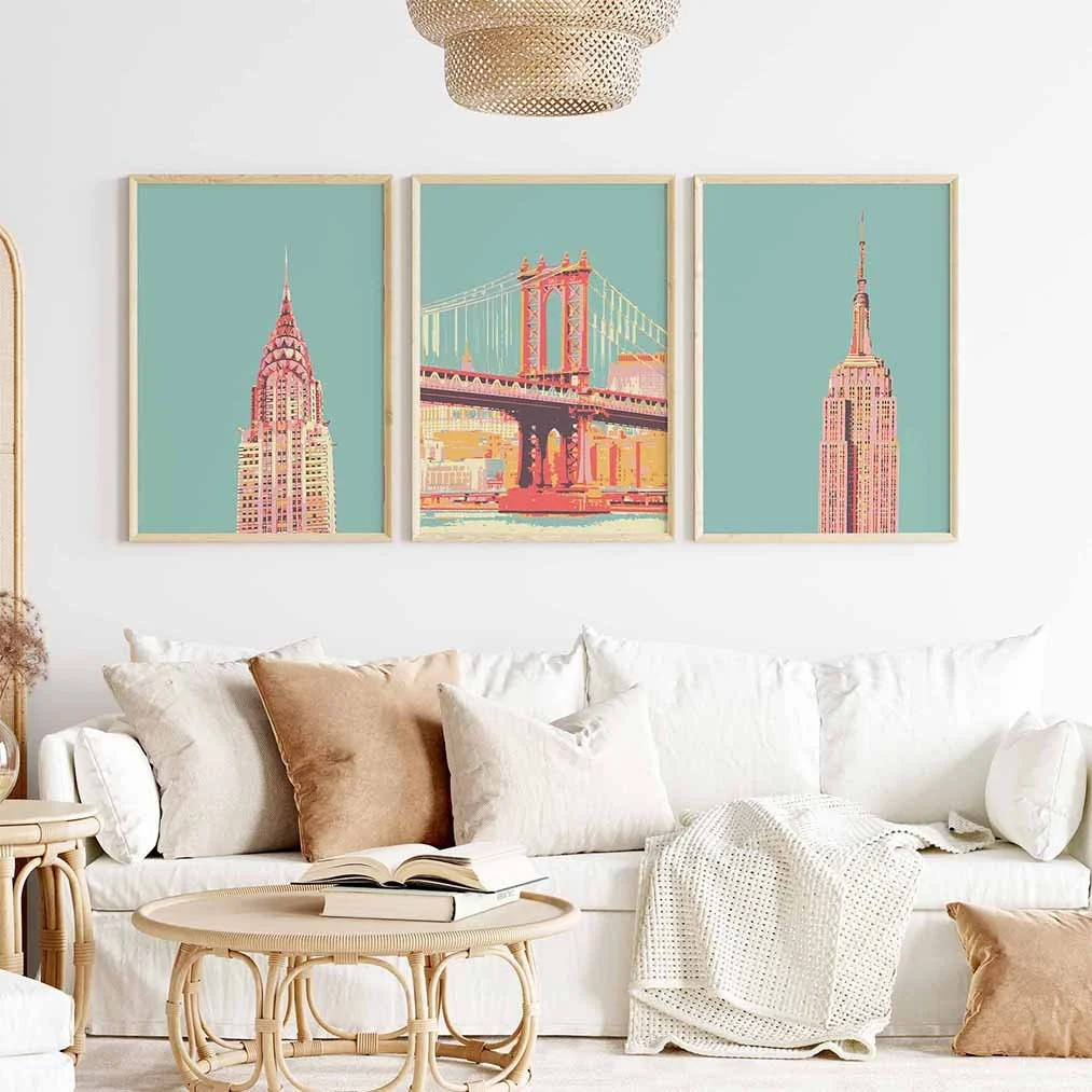 Frontal view of a boho living-room featuring 3 New York travel posters in a greenish blue hue on the wall.