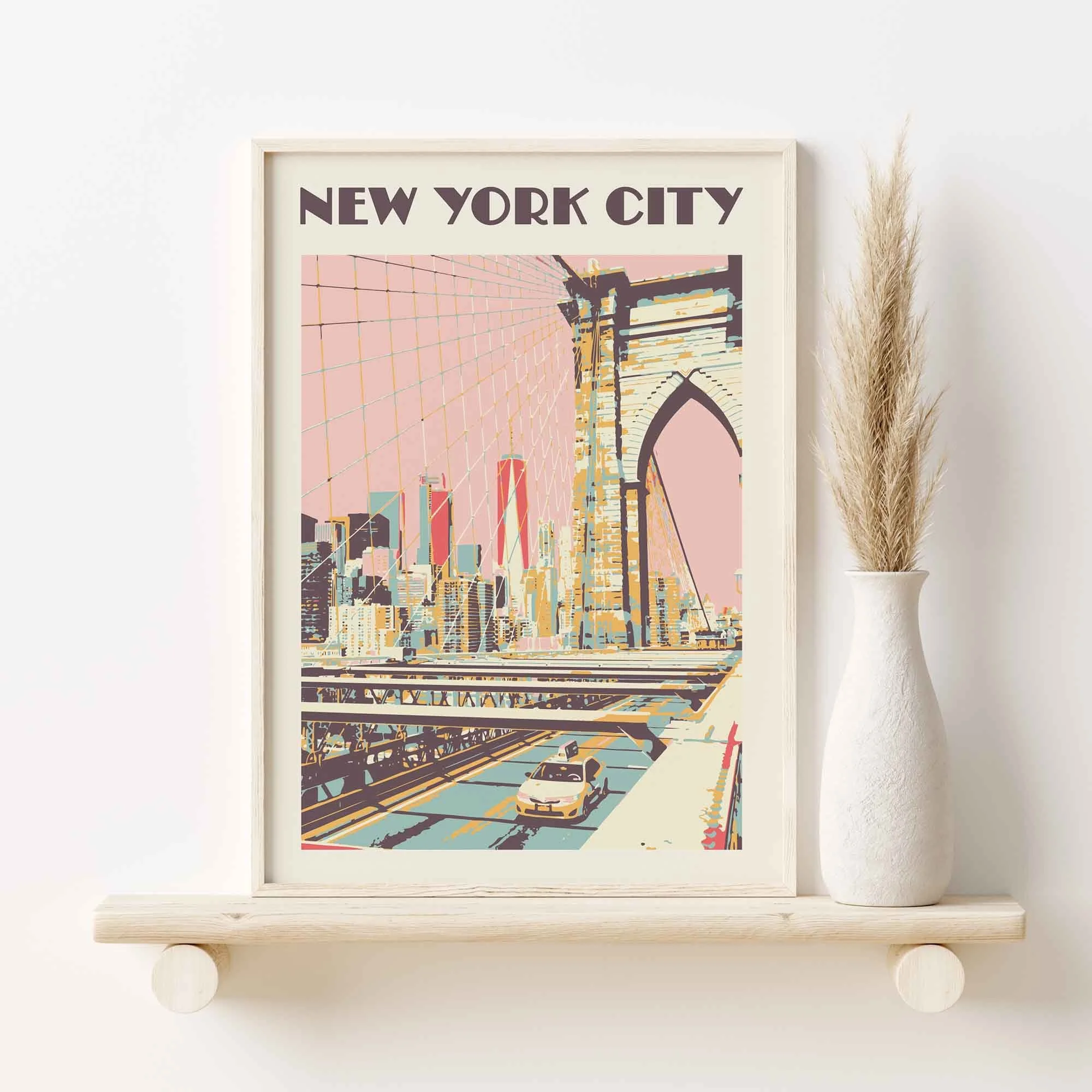 A poster featuring the Brooklyn Bridge against a pink sky, on a shelf.