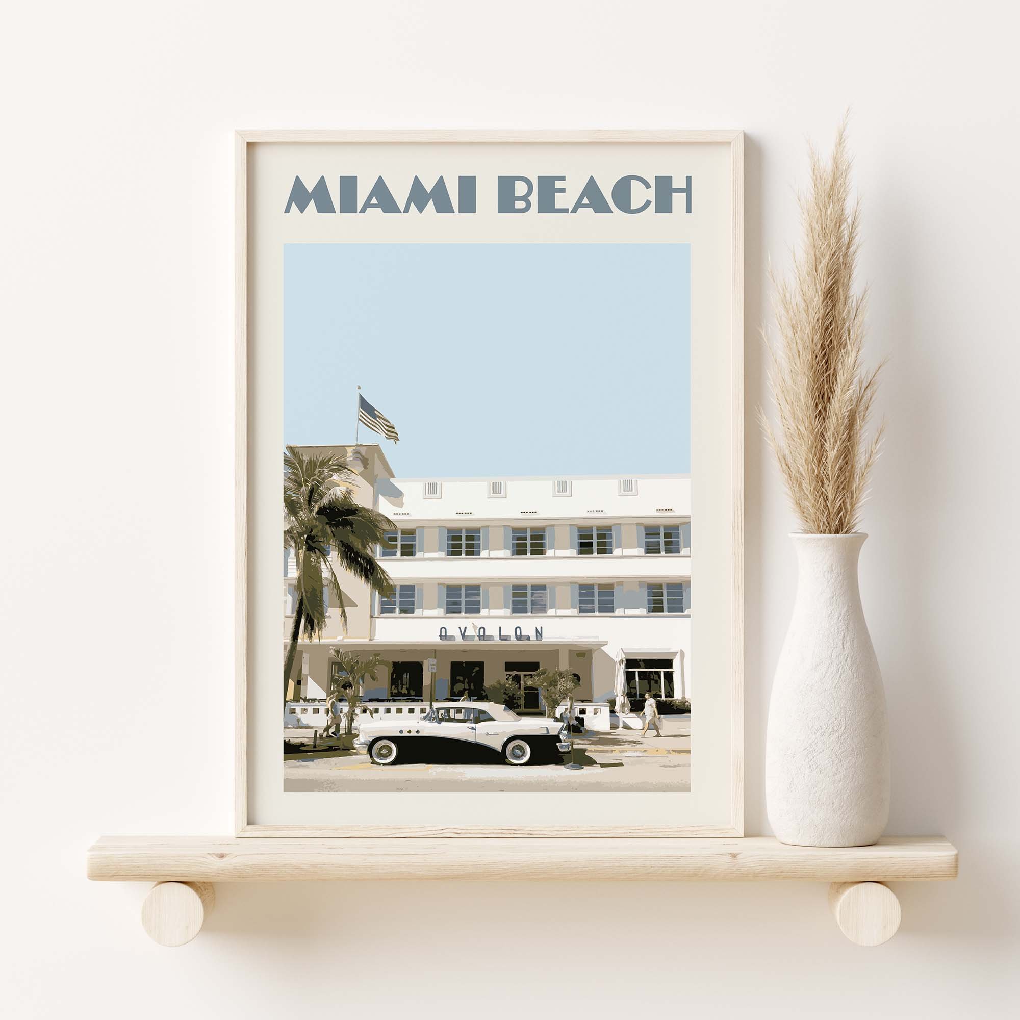 A framed poster featuring an Art Deco building in Miami Beach.